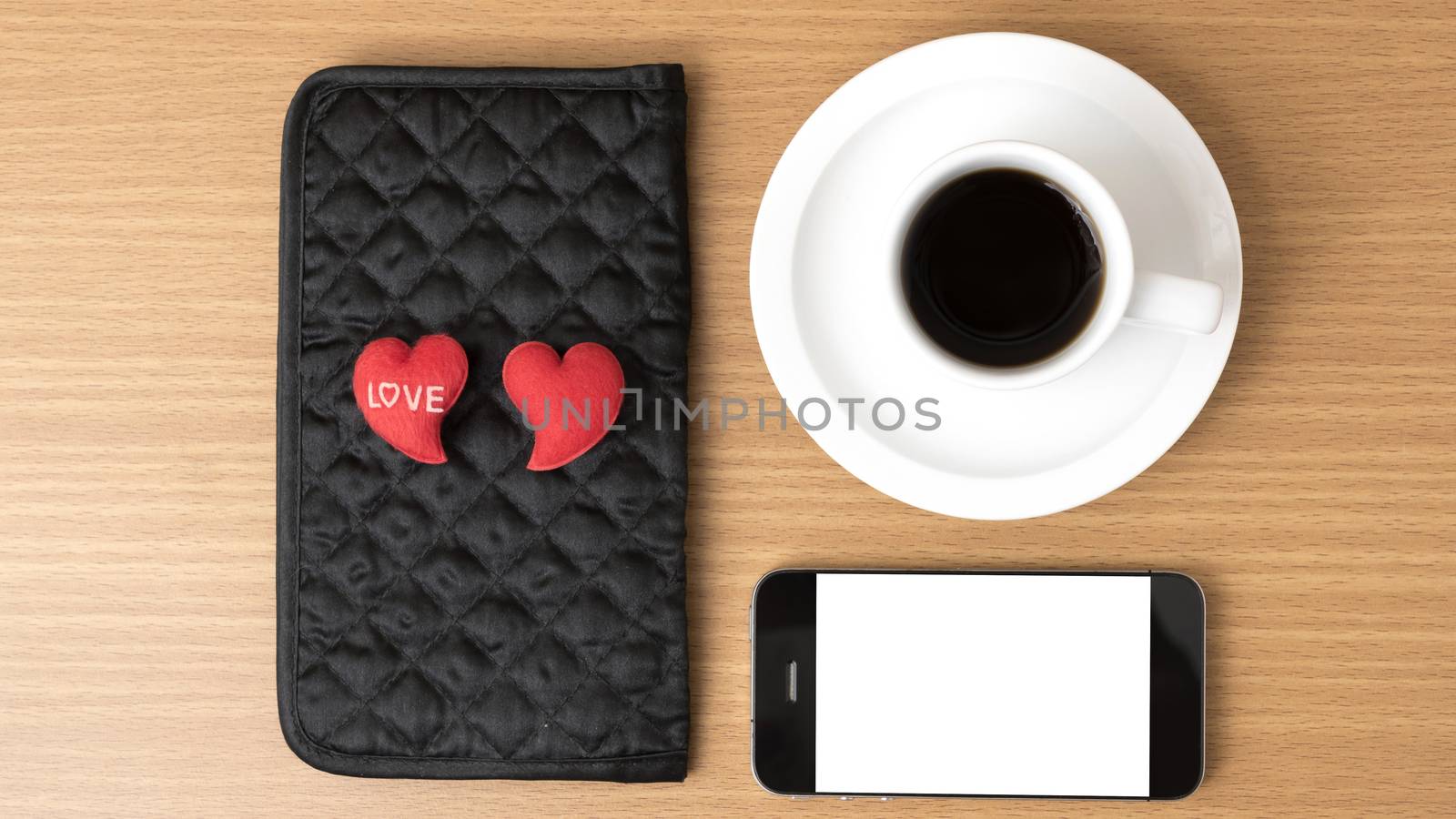 coffee,phone,wallet and heart on wood table background