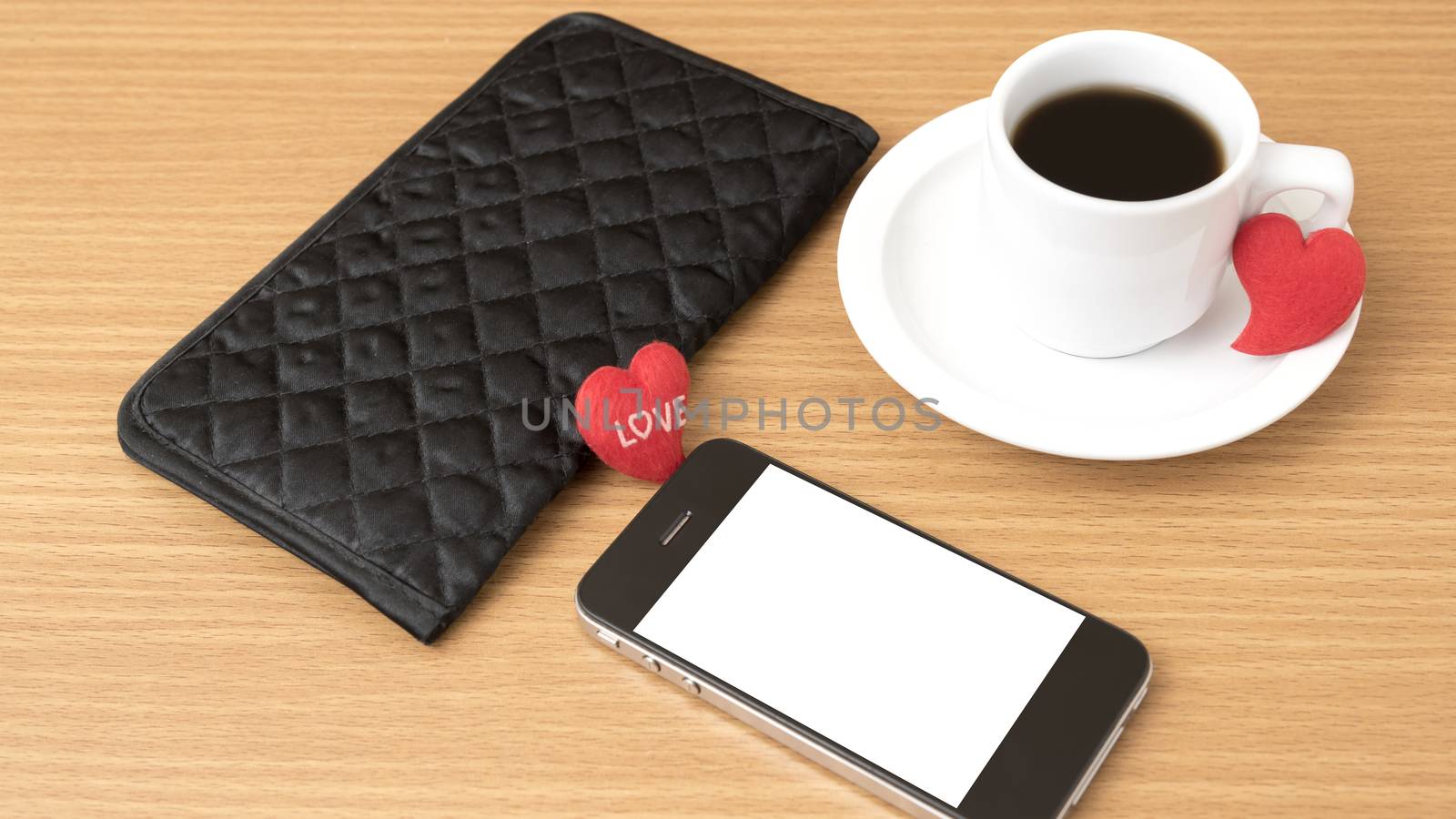 coffee,phone,wallet and heart on wood table background