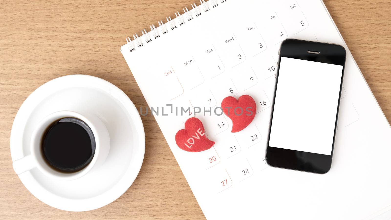 coffee,phone,calendar and heart on wood table background