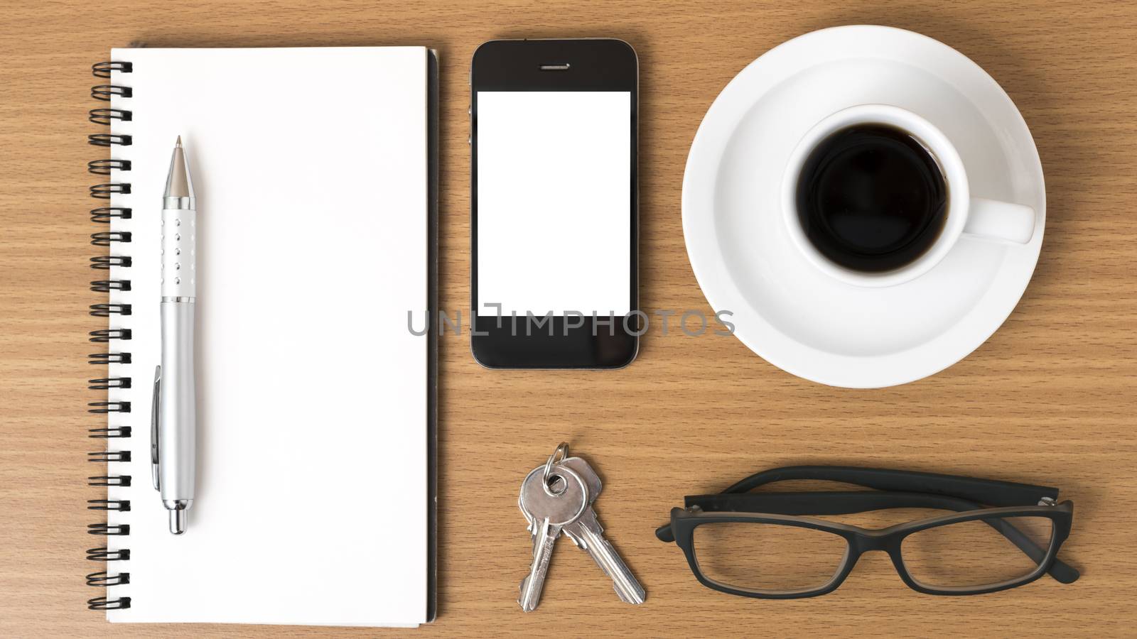 coffee,phone,notepad,eyeglasses and key on wood table background