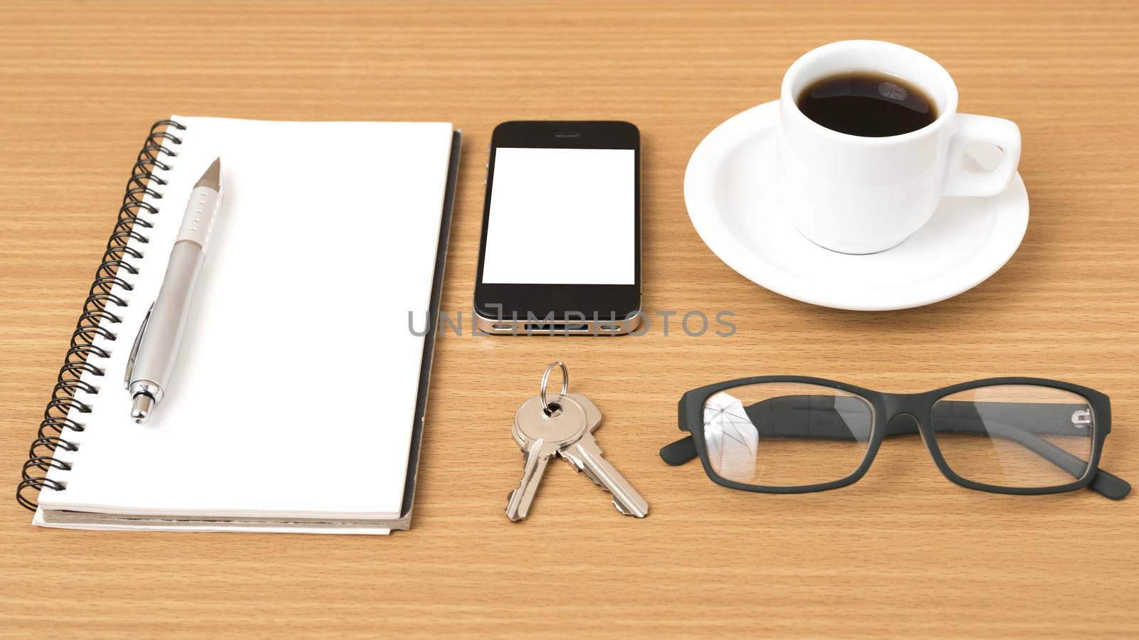 coffee,phone,notepad,eyeglasses and key on wood table background