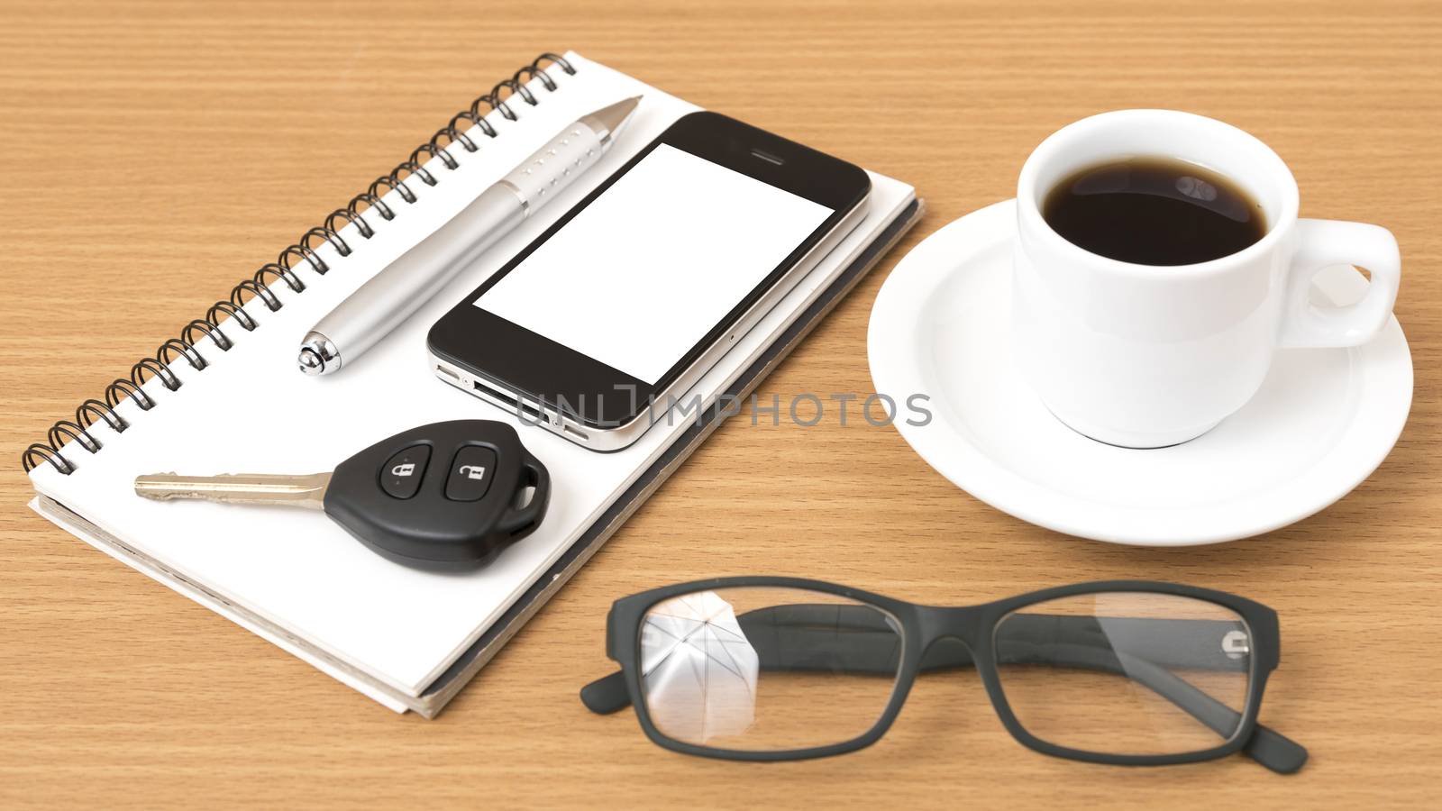 coffee,phone,notepad,eyeglasses and car key on wood table background