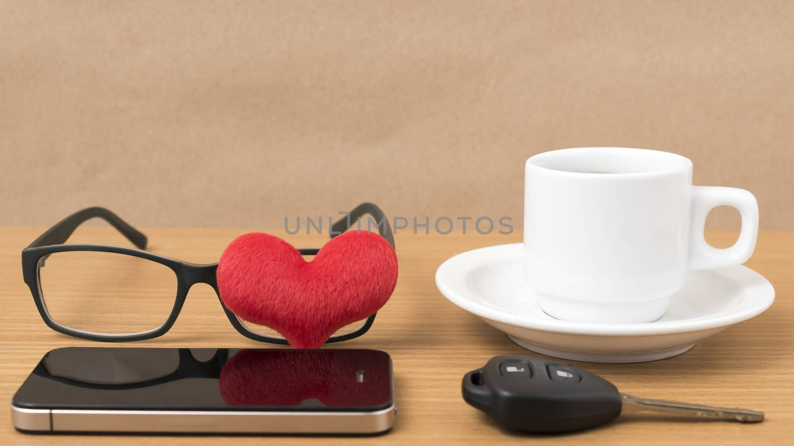 coffee,phone,eyeglasses and car key on wood table background