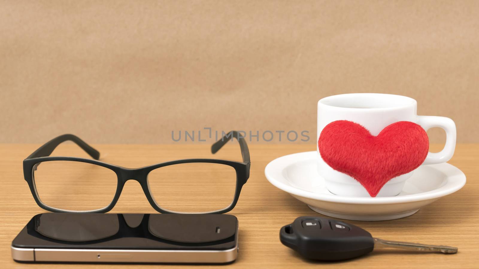 coffee,phone,eyeglasses and car key on wood table background