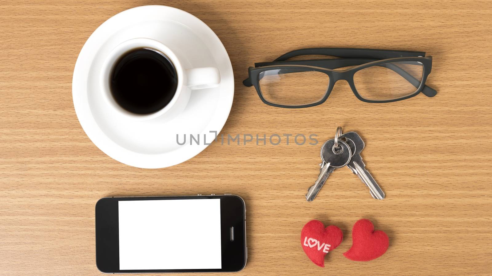 coffee,phone,eyeglasses and key on wood table background