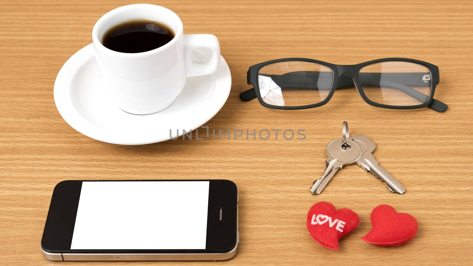 coffee,phone,eyeglasses and key on wood table background