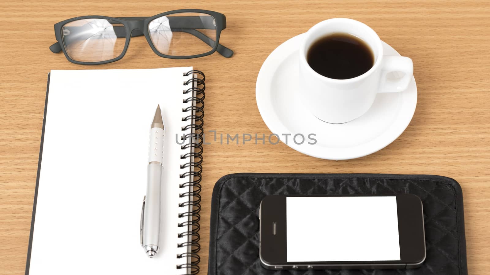 coffee,phone,eyeglasses,notepad and wallet on wood table background