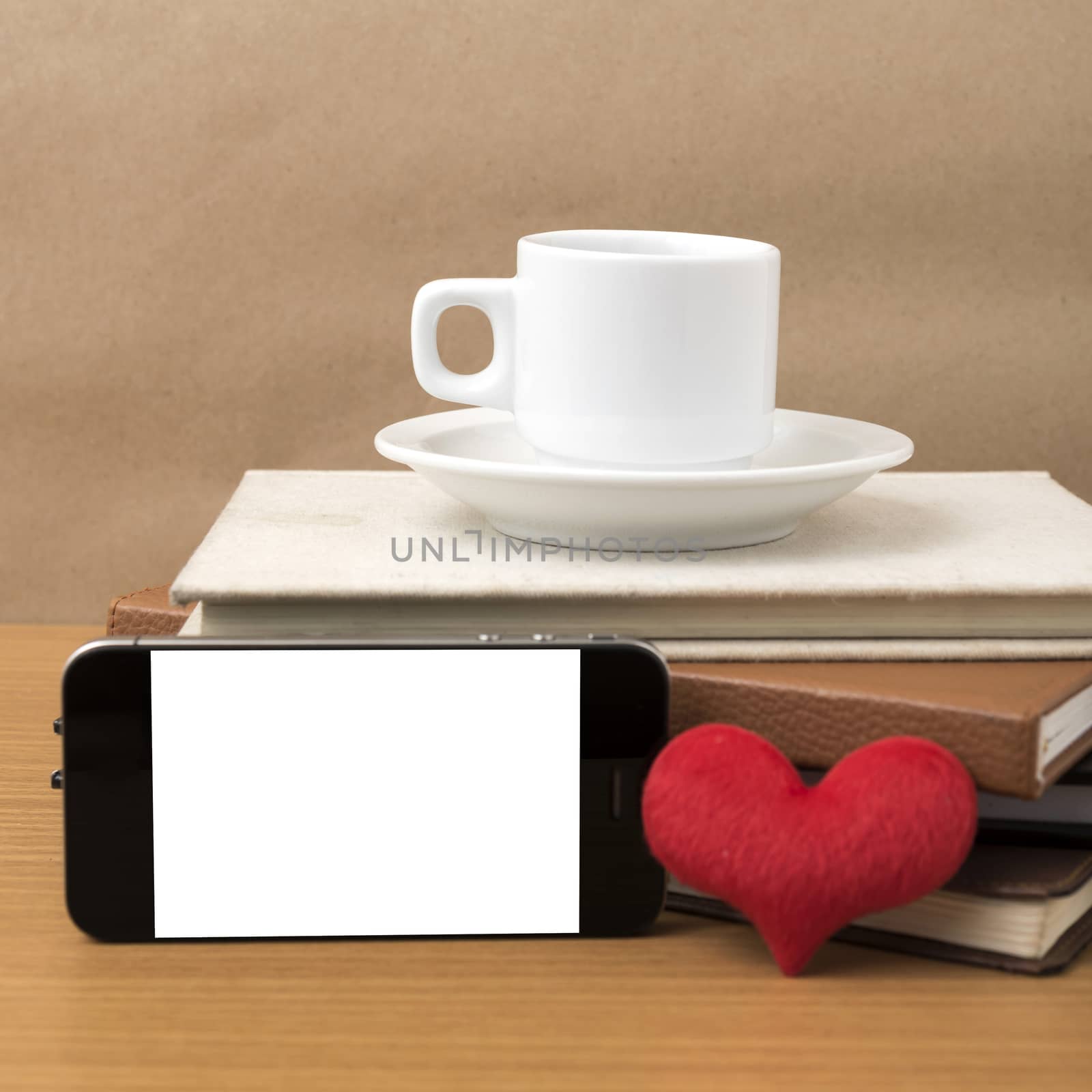 coffee,phone,stack of book and heart on wood table background