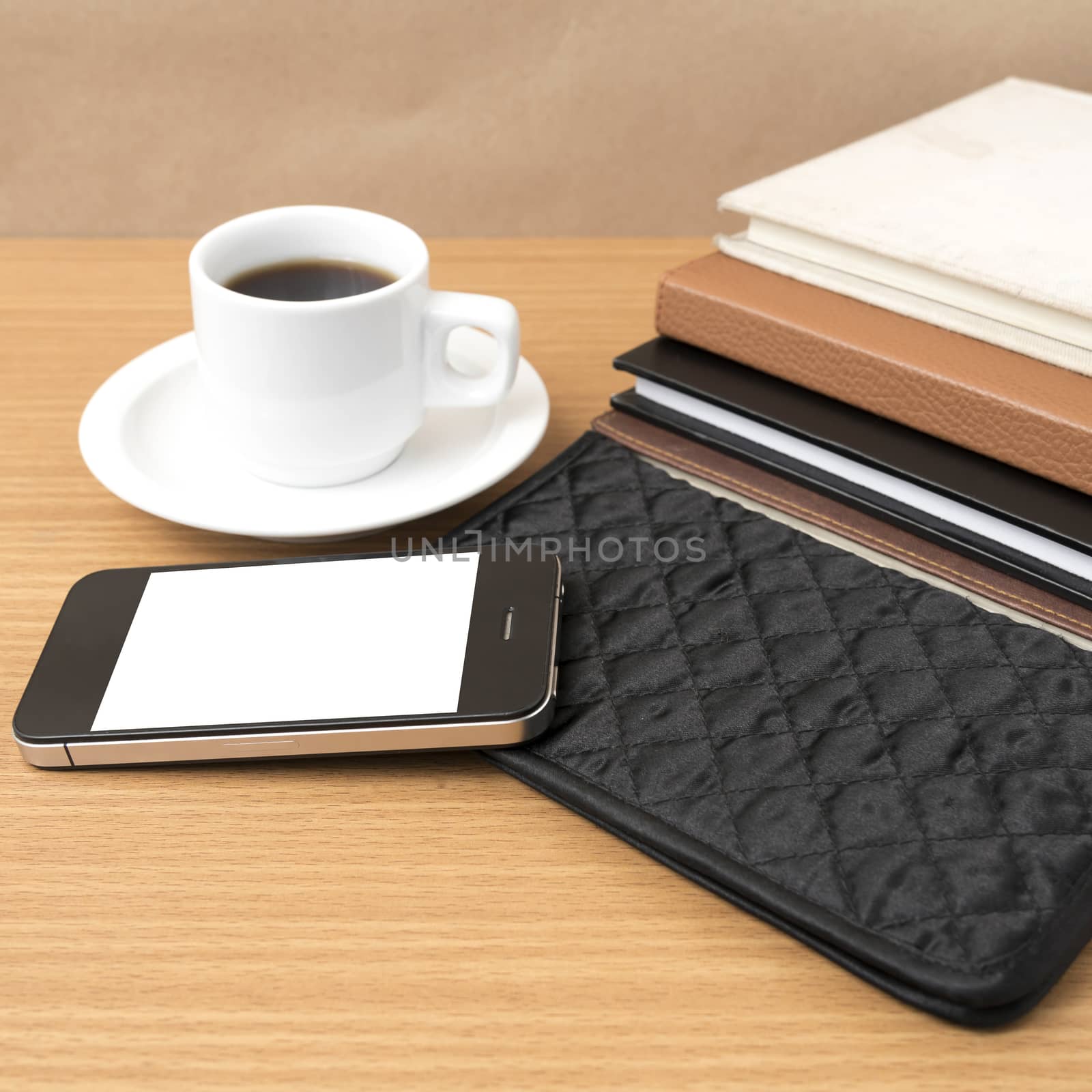 coffee,phone,stack of book and wallet on wood table background