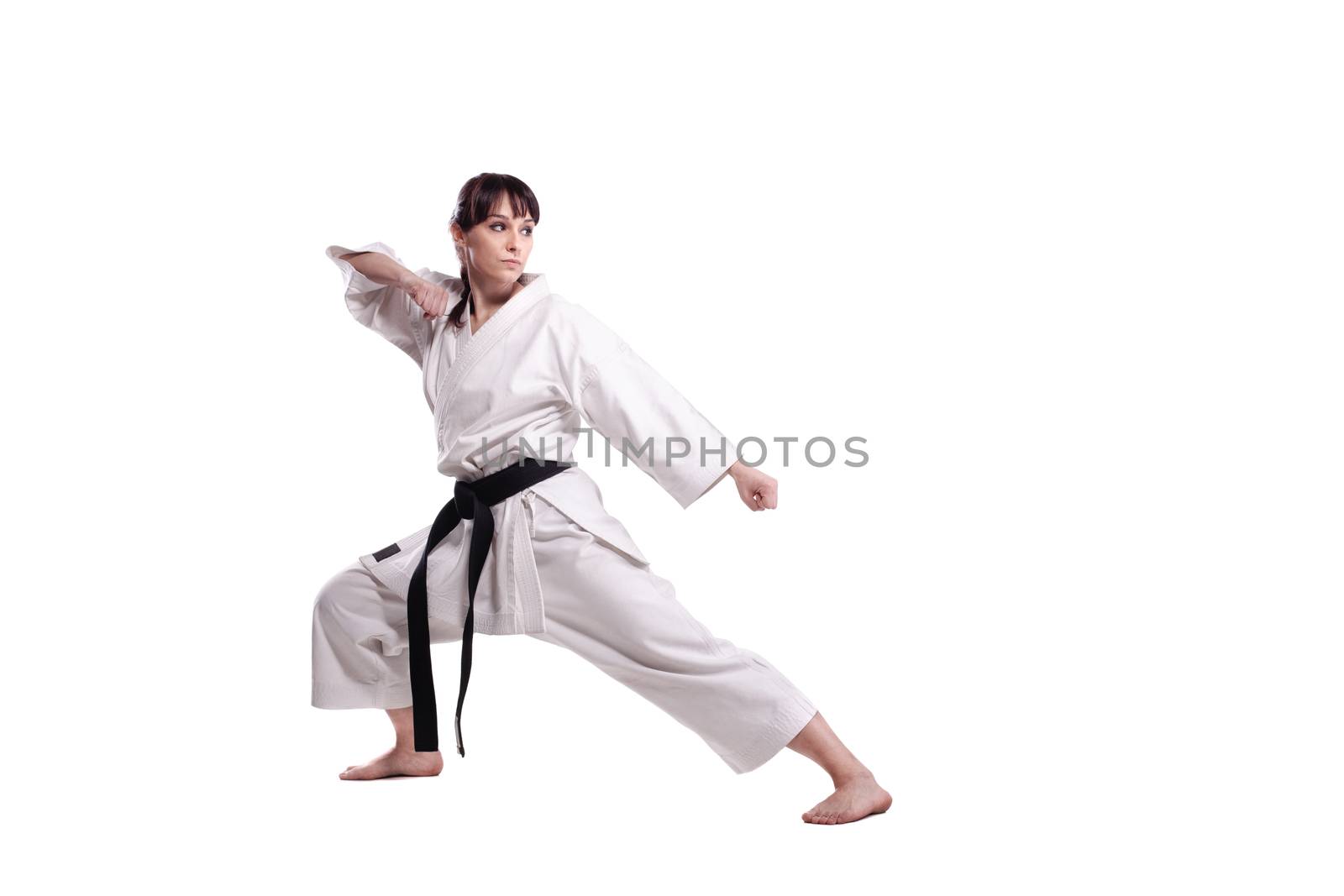 girl exercising karate, against white background