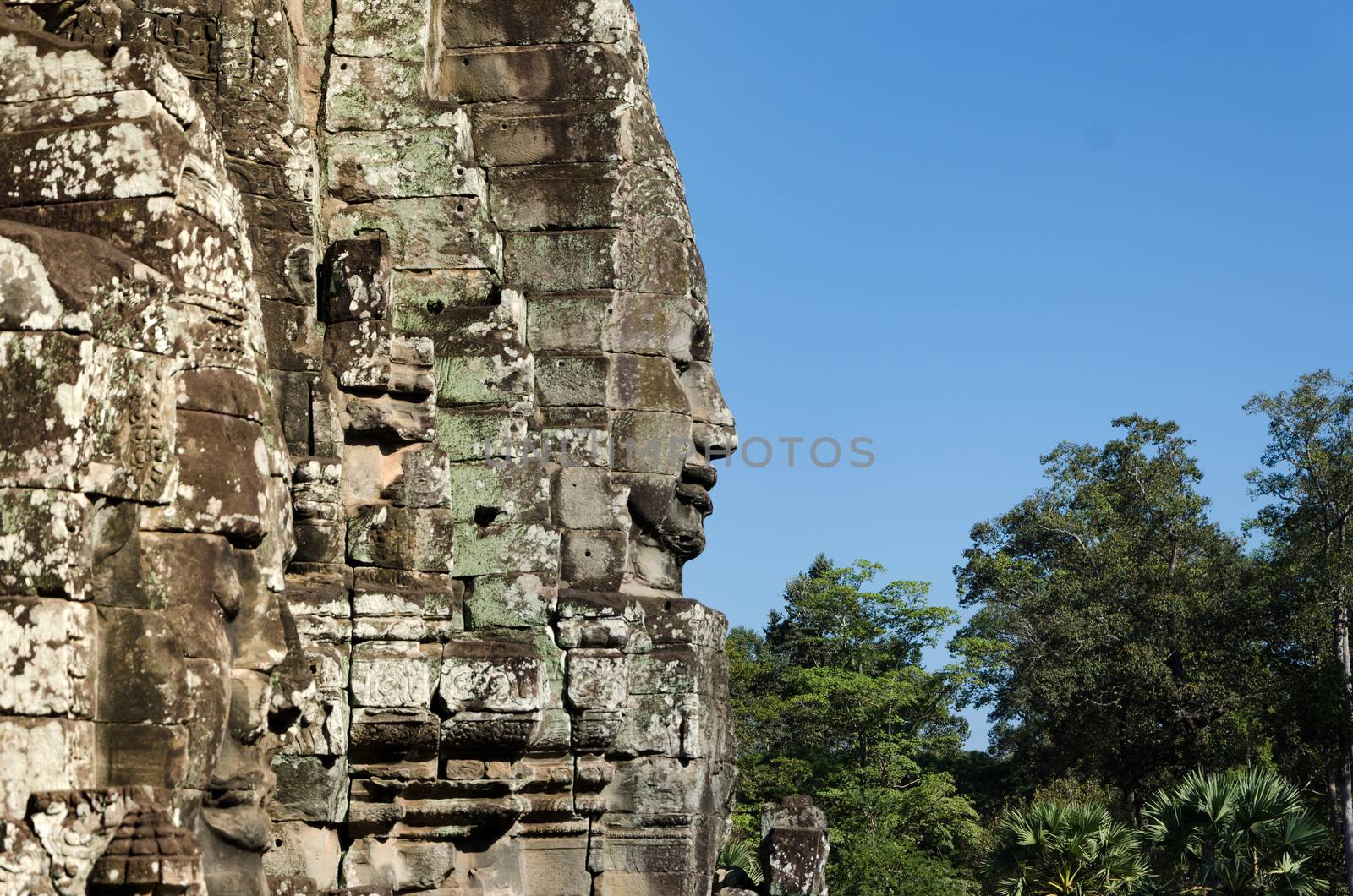 Faces of Bayon temple in Angkor Thom by siraanamwong