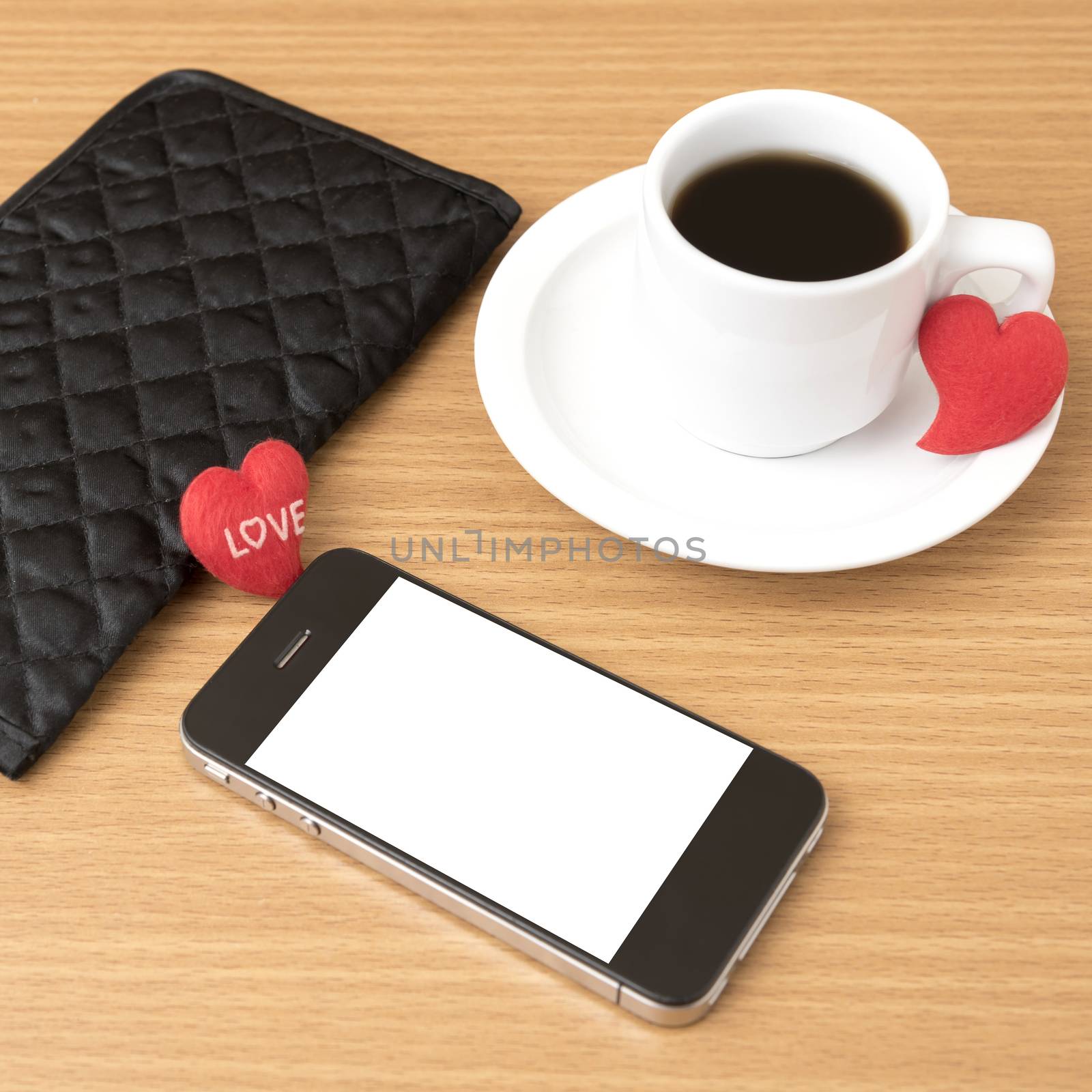 coffee,phone,wallet and heart on wood table background