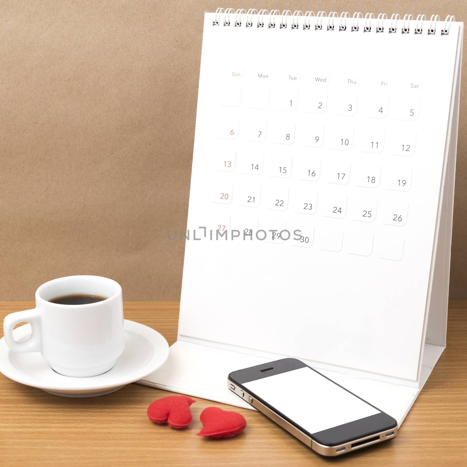 coffee,phone,calendar and heart on wood table background