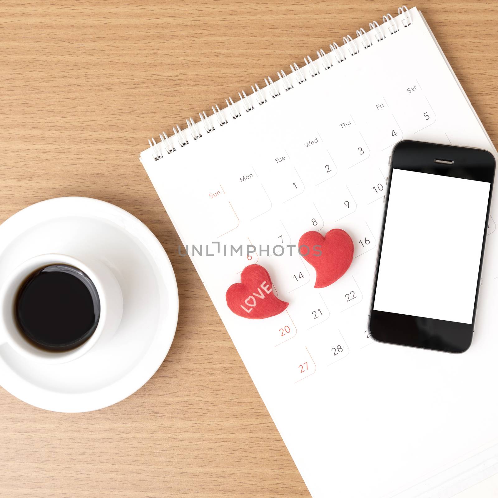 coffee,phone,calendar and heart on wood table background