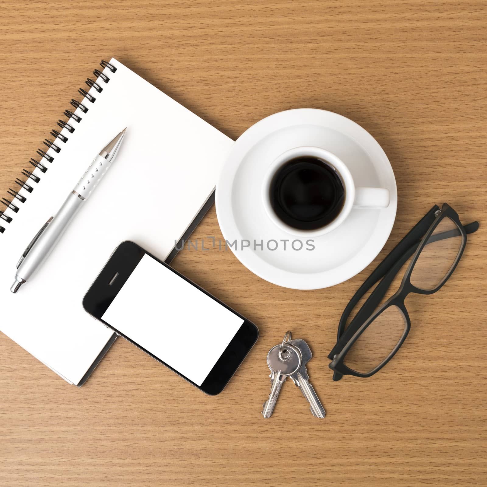 coffee,phone,notepad,eyeglasses and key on wood table background