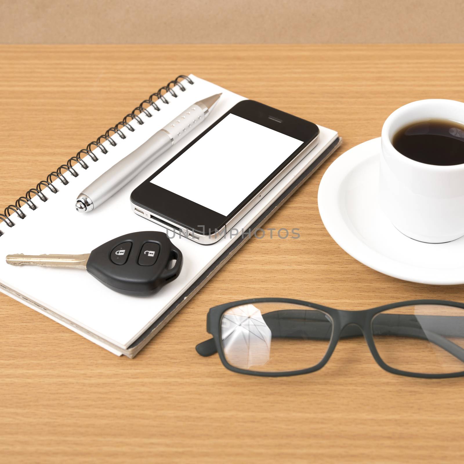 coffee,phone,notepad,eyeglasses and car key on wood table background