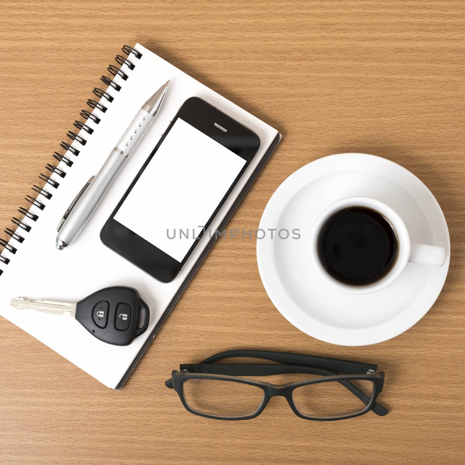 coffee,phone,notepad,eyeglasses and car key on wood table background