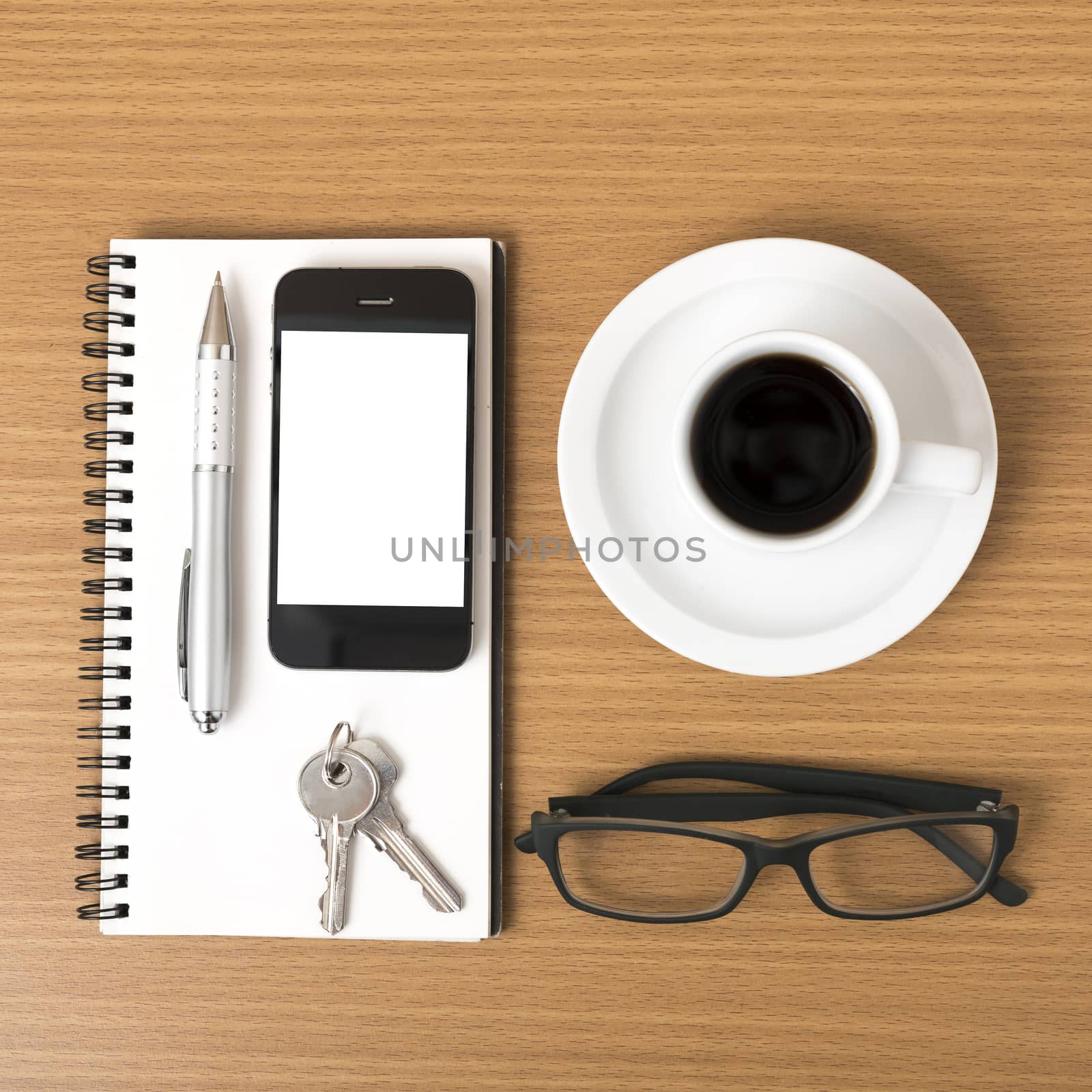 coffee,phone,notepad,eyeglasses and key on wood table background