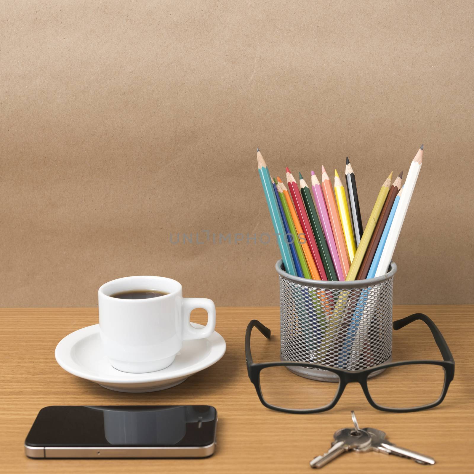 coffee,phone,eyeglasses,color pencil and key on wood table background