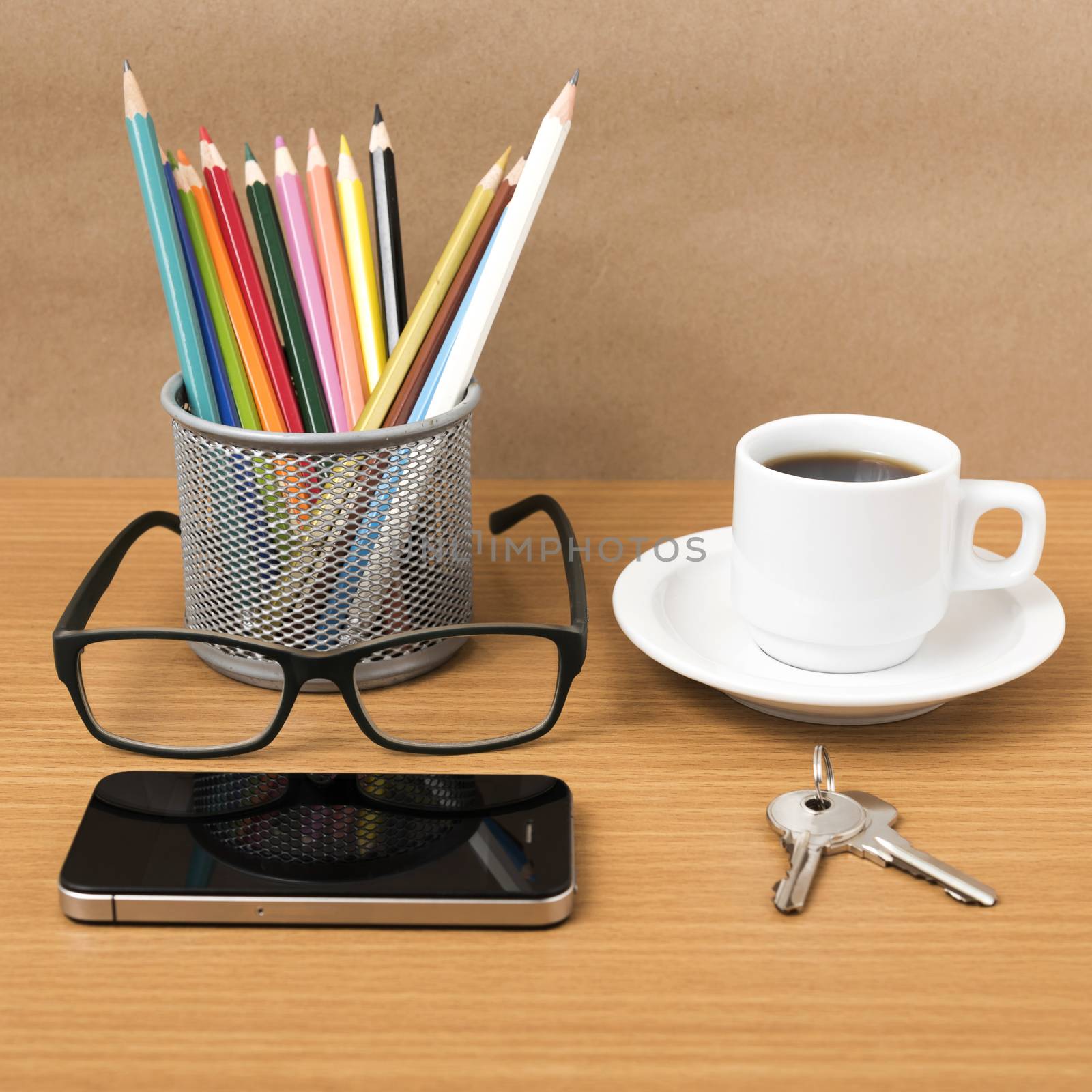 coffee,phone,eyeglasses,color pencil and key on wood table background