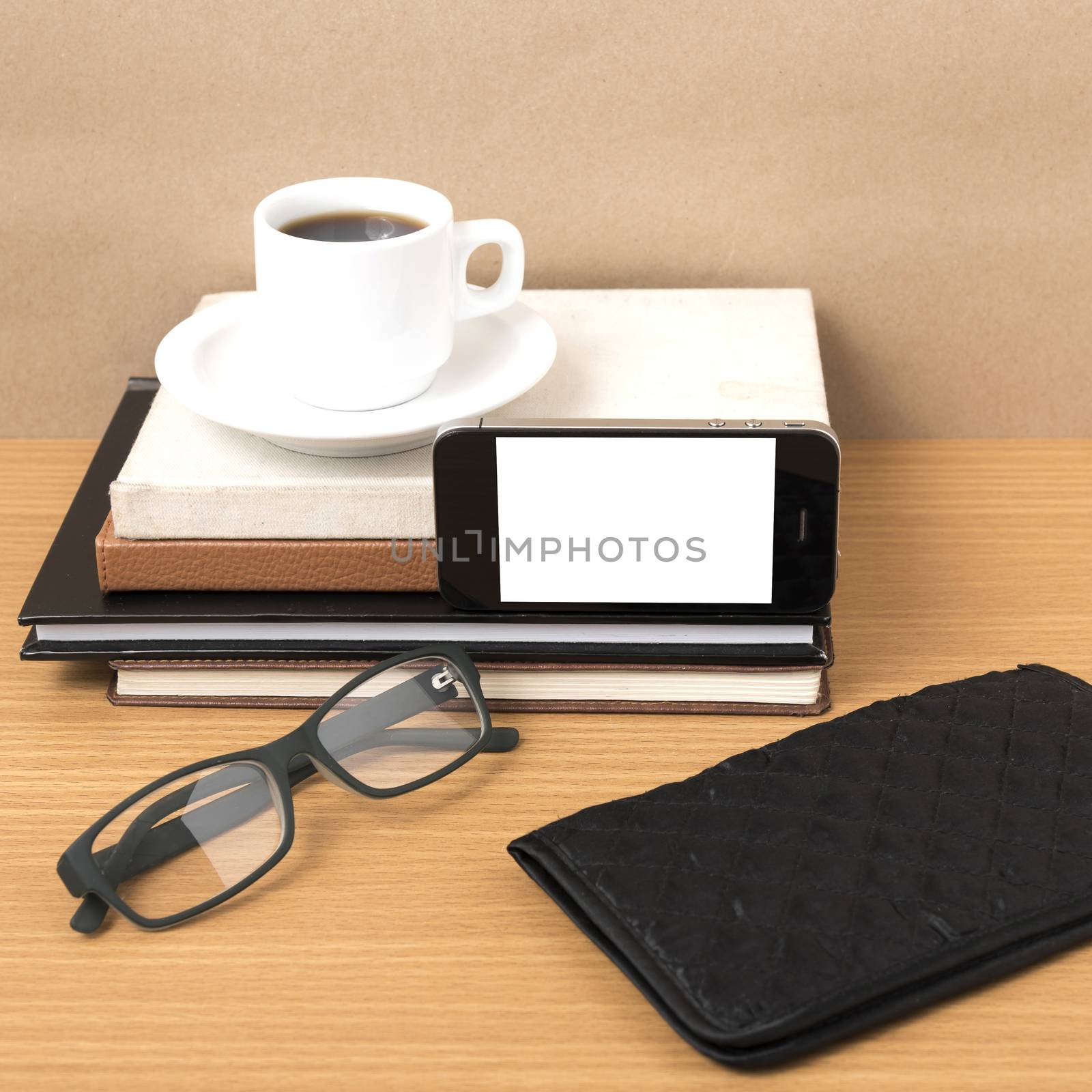 coffee,phone,eyeglasses,stack of book and wallet on wood table background