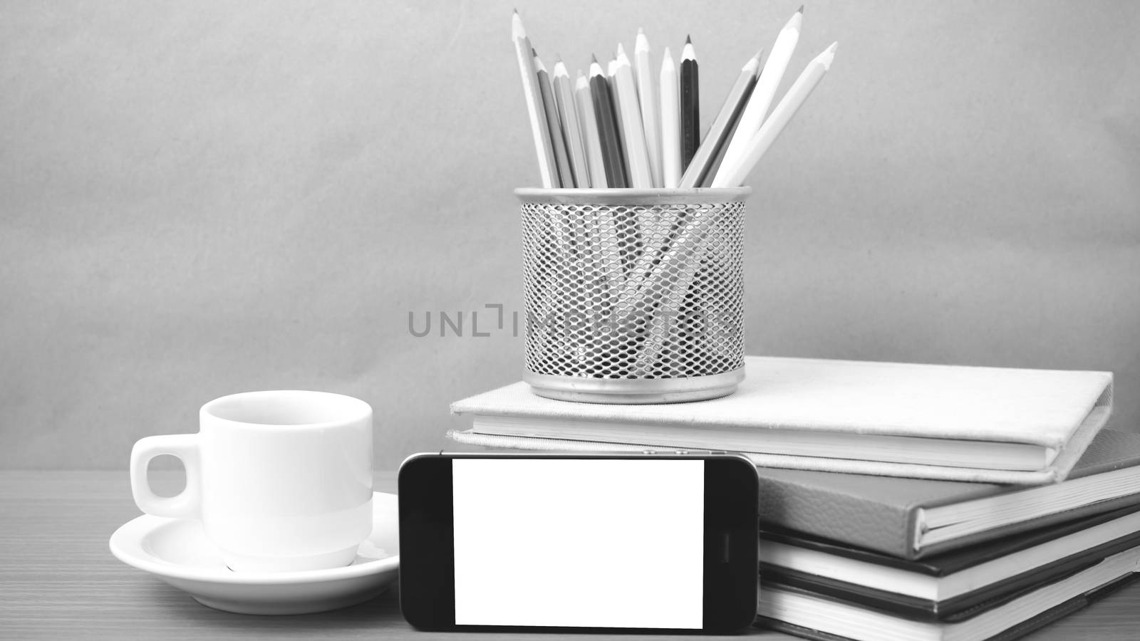 coffee,phone,stack of book and color pencil on wood table background black and white color