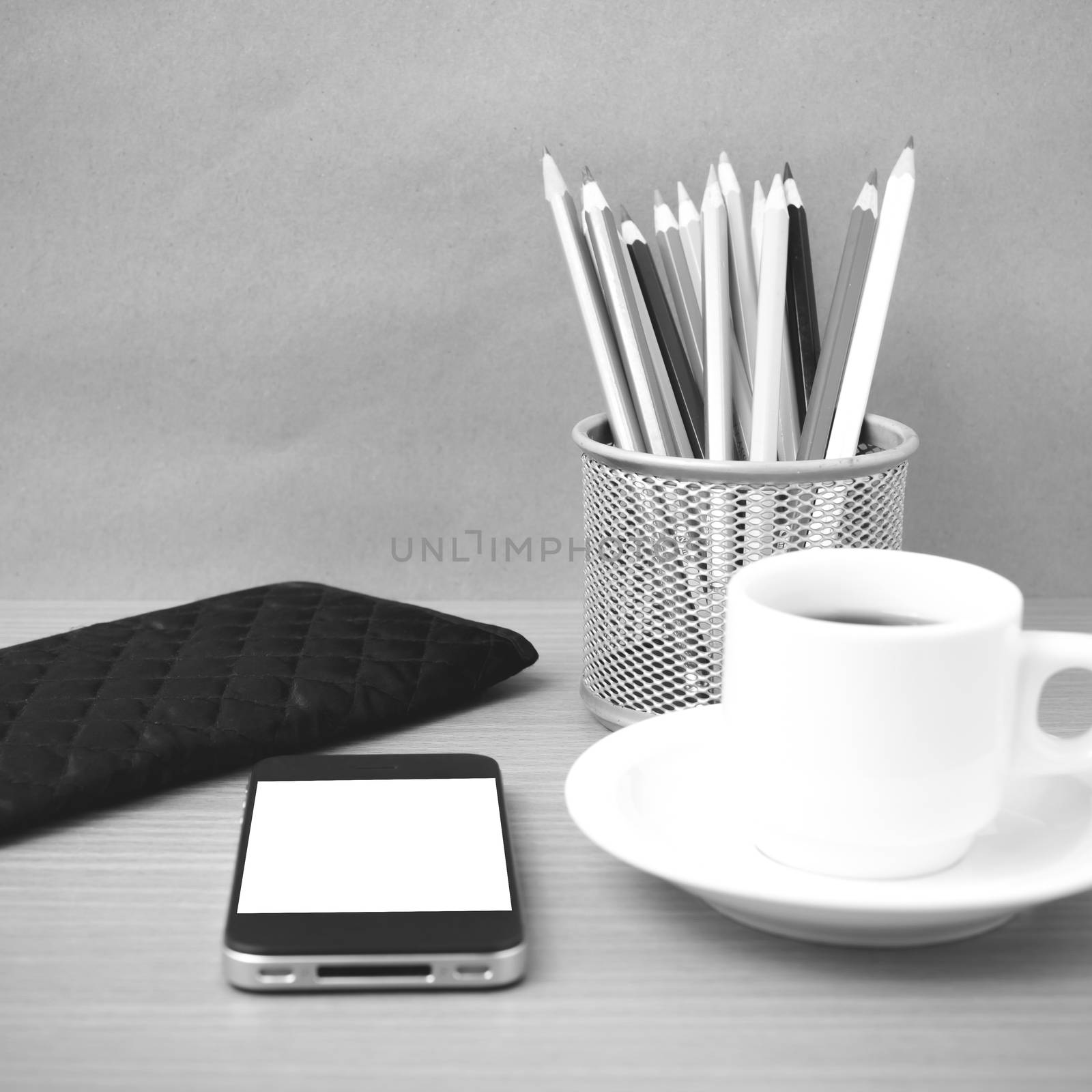 coffee,phone,wallet and color pencil on wood table background black and white color