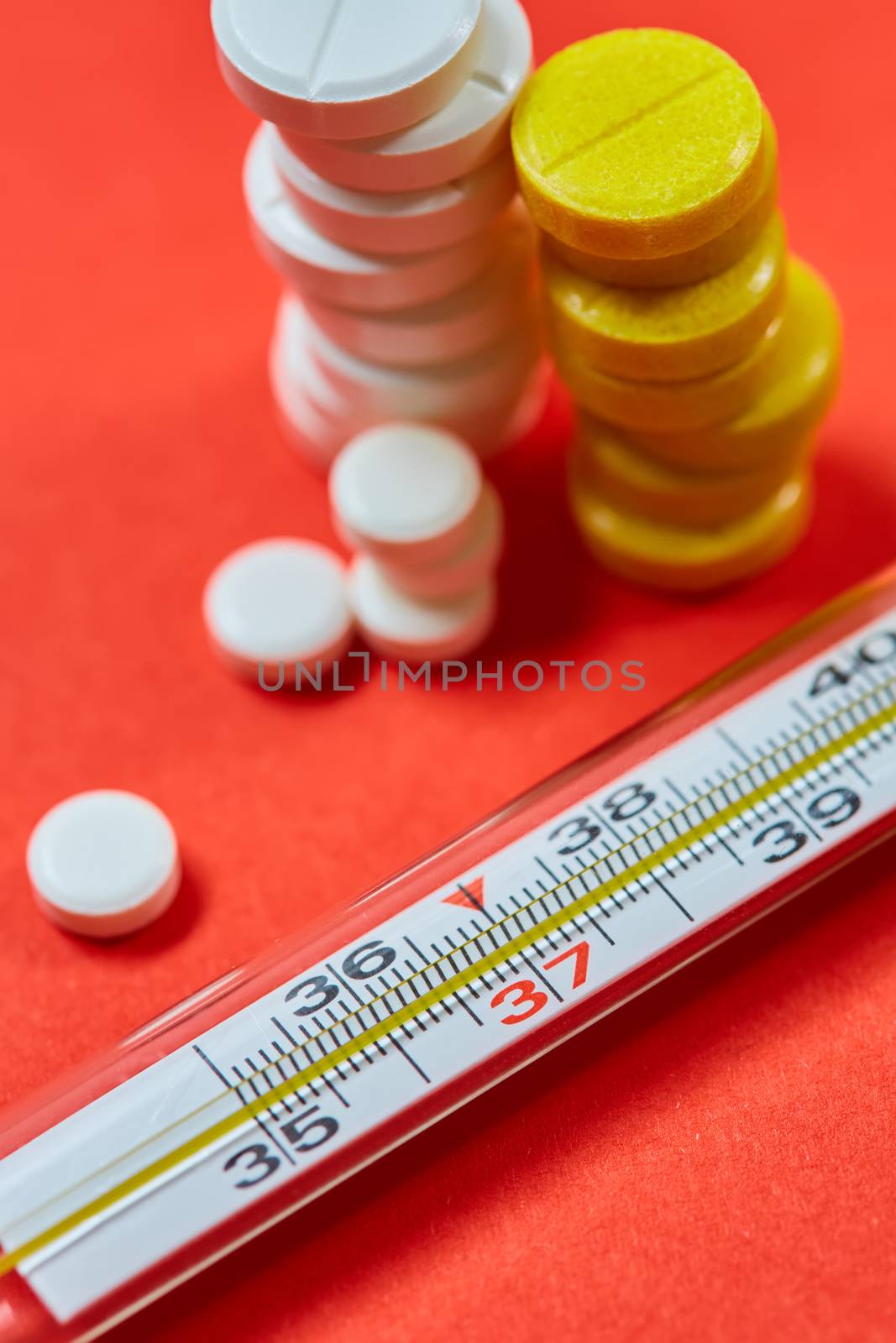 Mercury thermometer and medical pills on background by sarymsakov