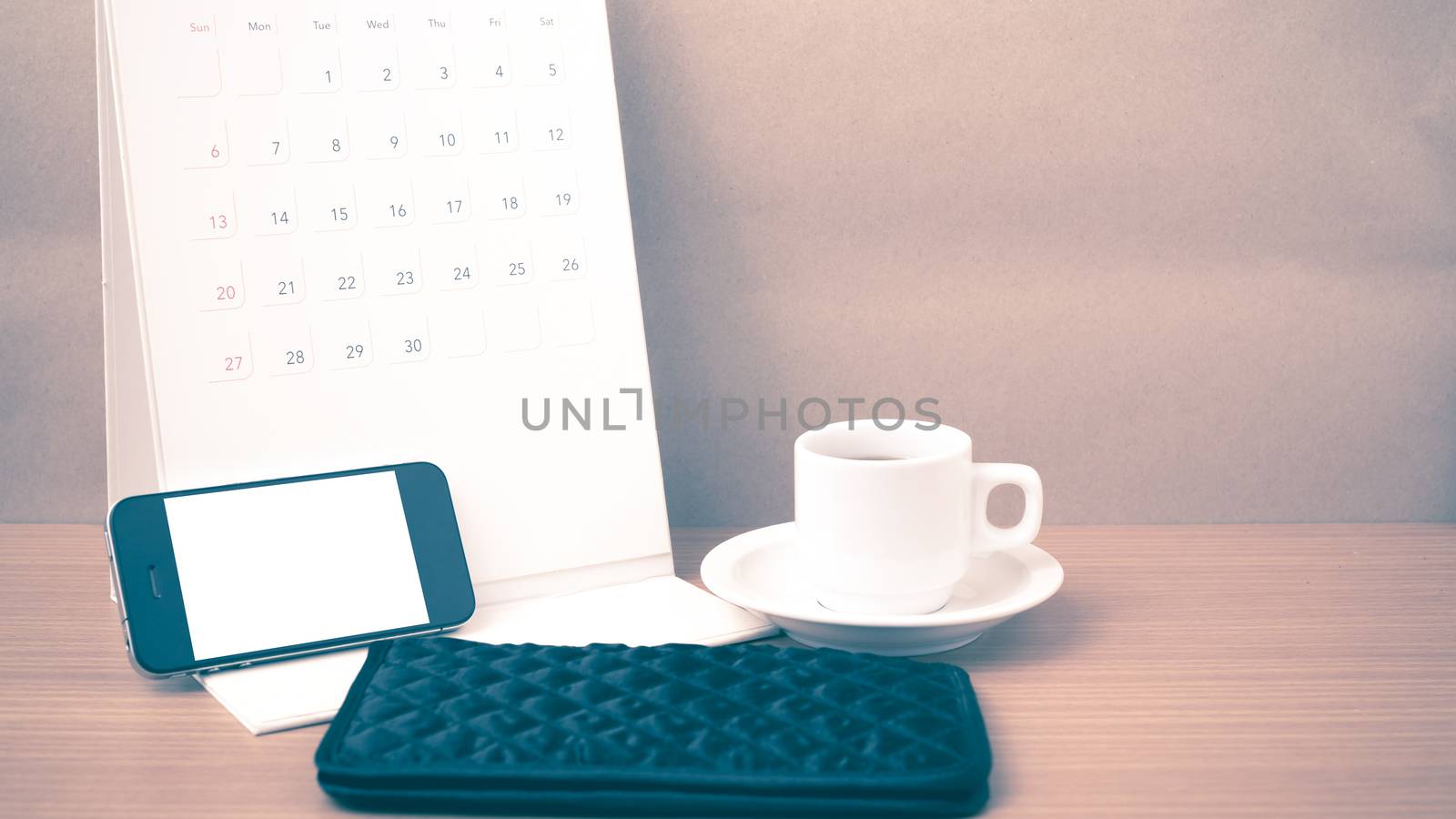 coffee,phone,wallet and canlendar on wood table background vintage style