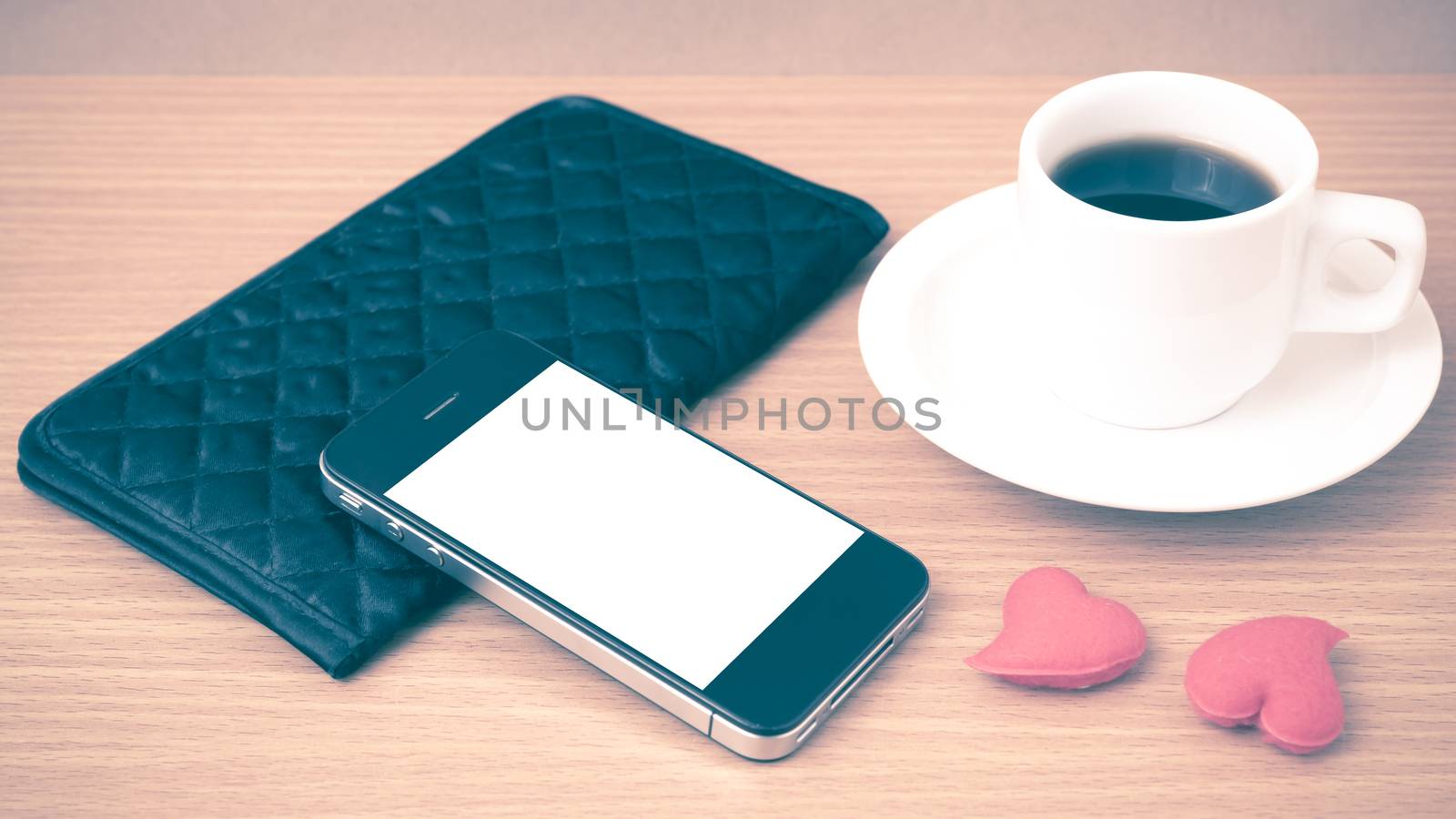 coffee,phone,wallet and heart on wood table background vintage style
