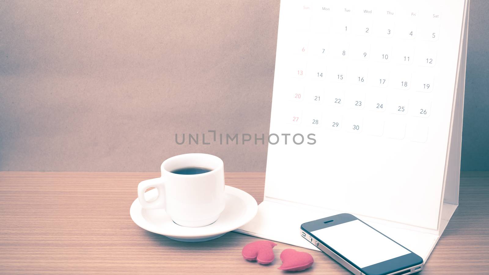 coffee,phone,calendar and heart on wood table background vintage style