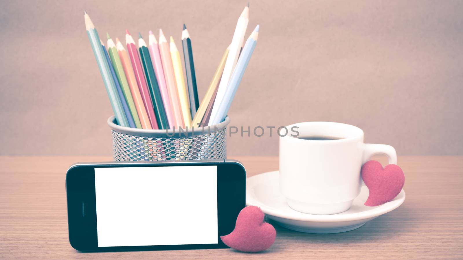 coffee,phone,color pencil and heart on wood table background vintage style