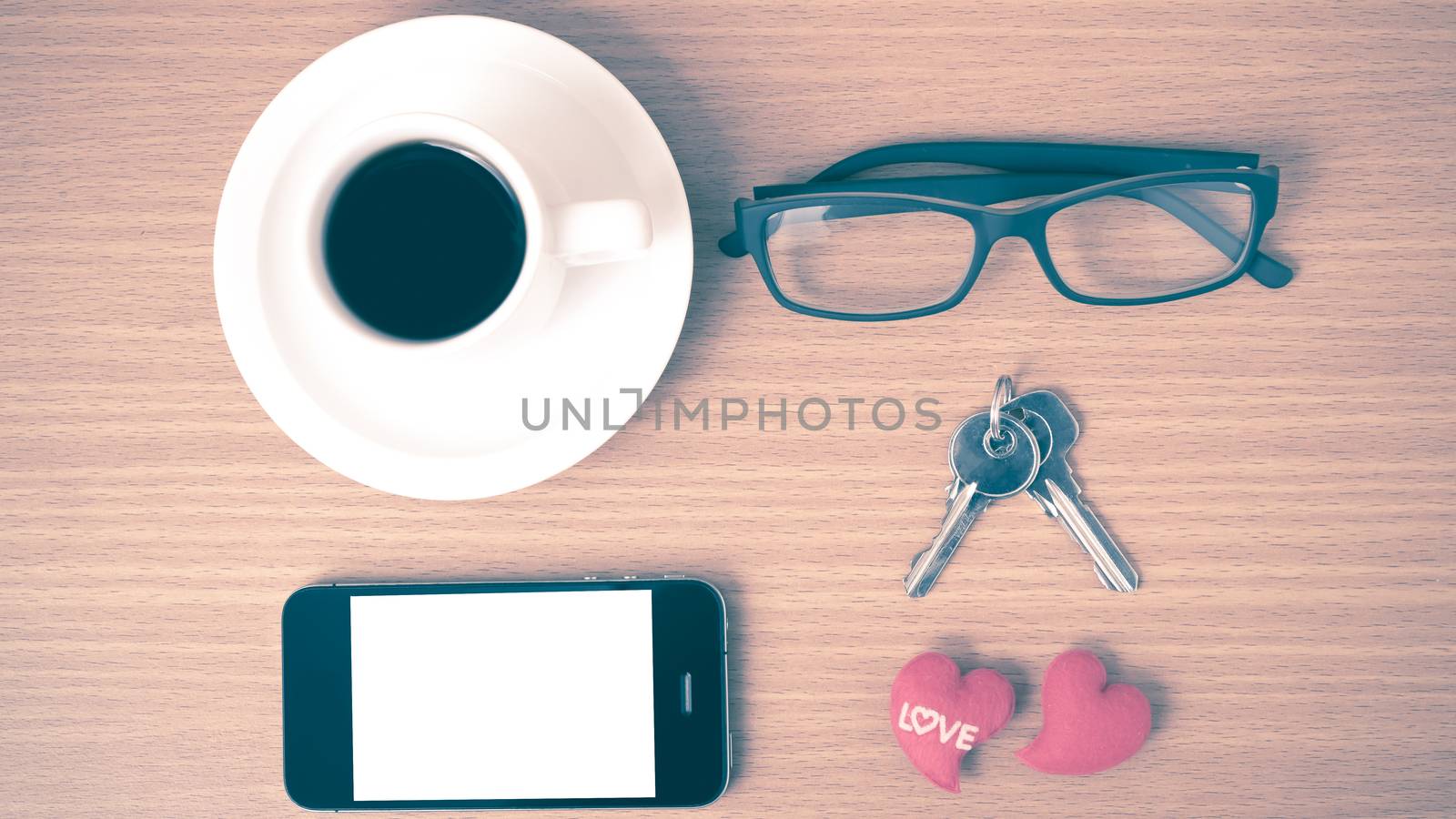 coffee,phone,eyeglasses and key on wood table background vintage style