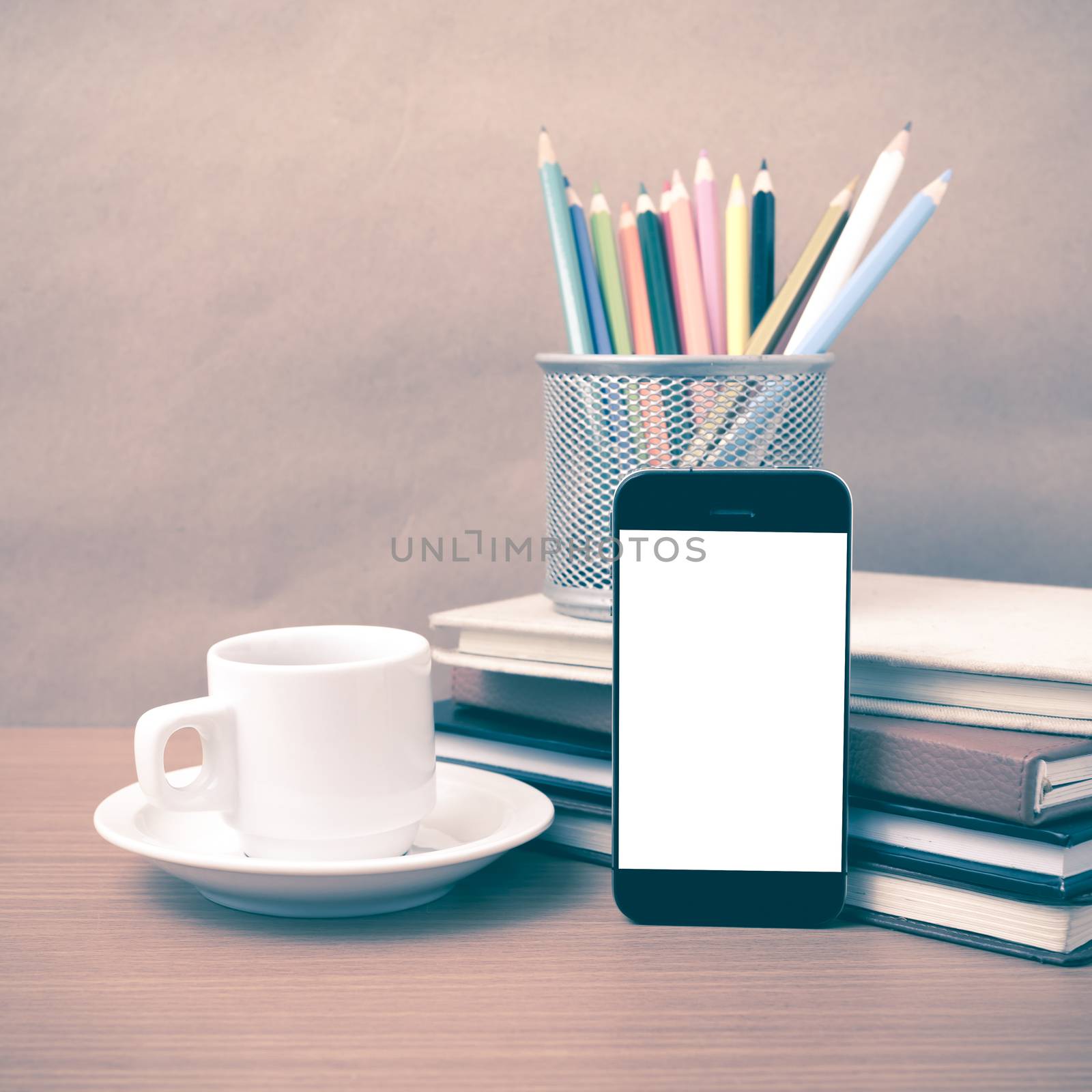 coffee,phone,stack of book and color pencil on wood table background vintage style