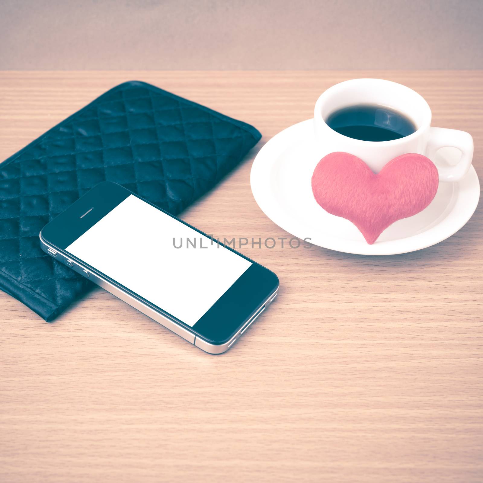 coffee,phone,wallet and heart on wood table background vintage style