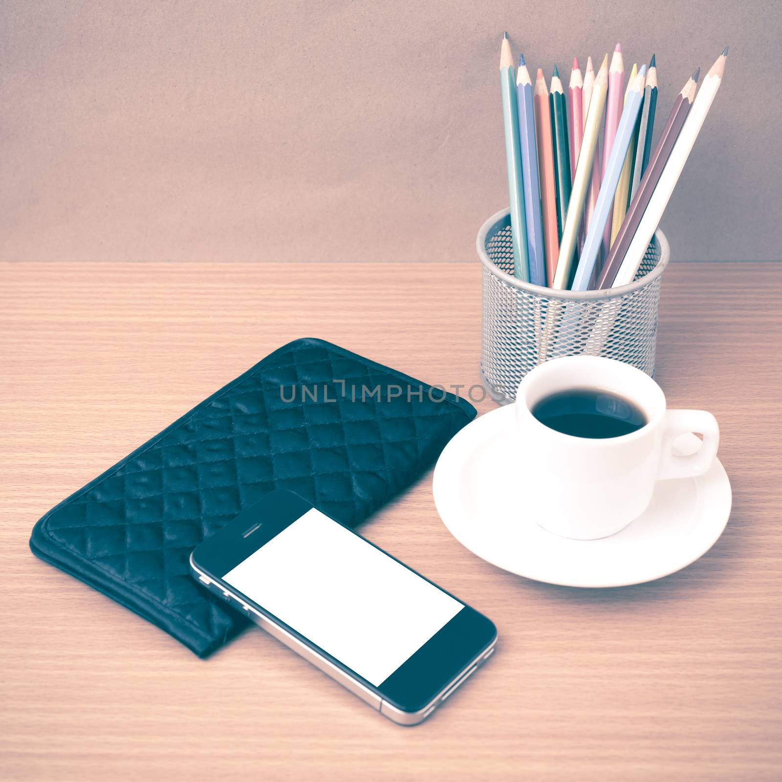 coffee,phone,wallet and color pencil on wood table background vintage style