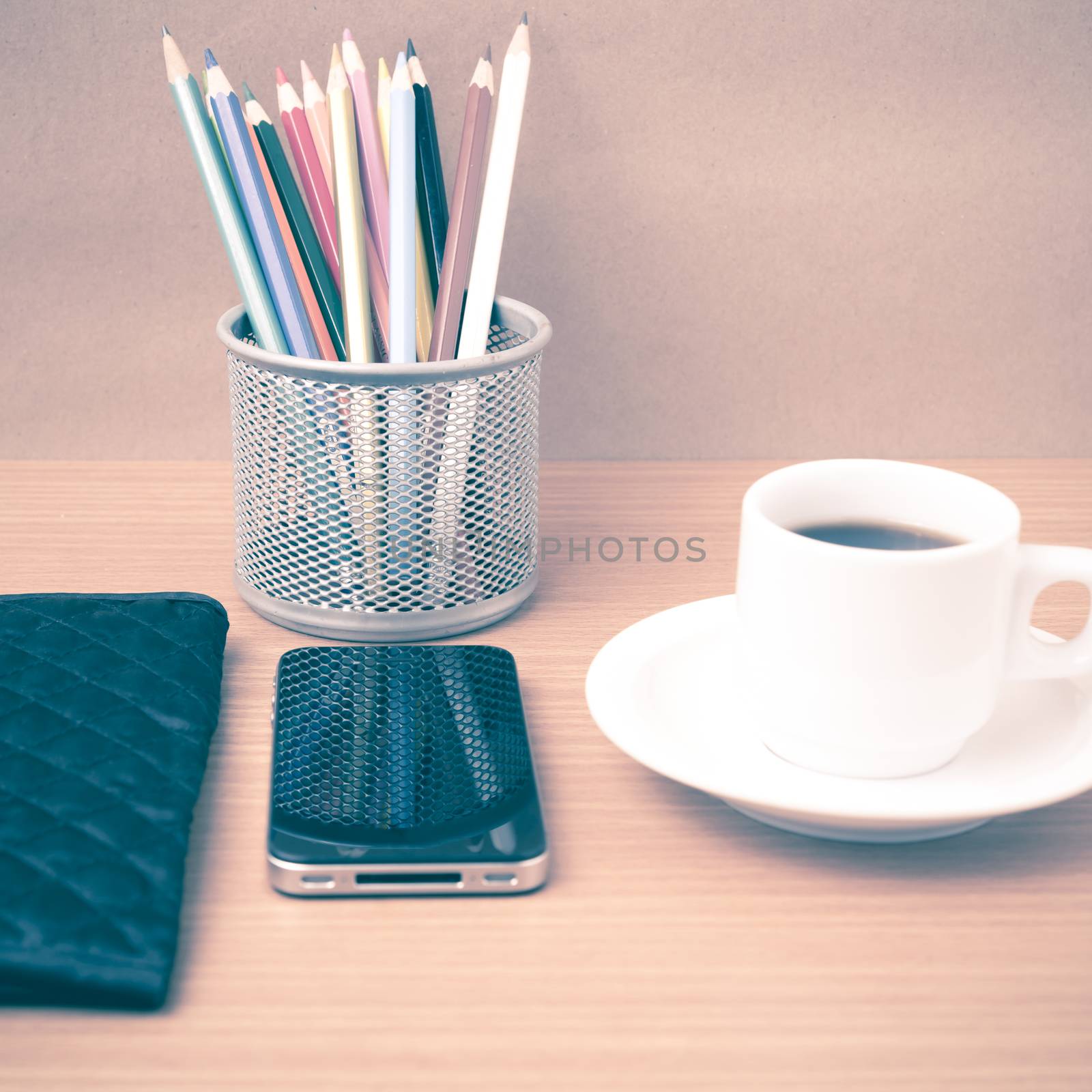 coffee,phone,wallet and color pencil on wood table background vintage style
