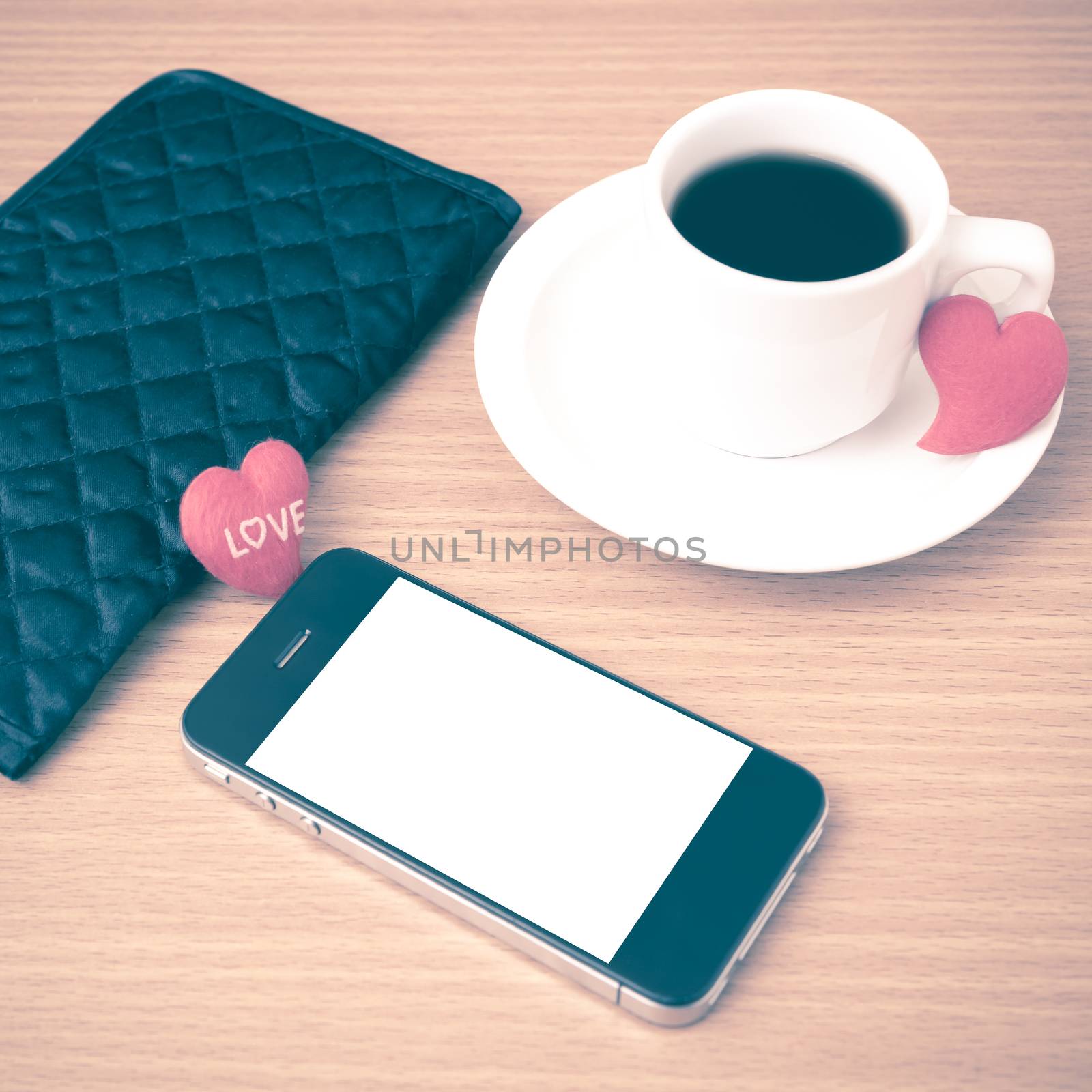 coffee,phone,wallet and heart on wood table background vintage style