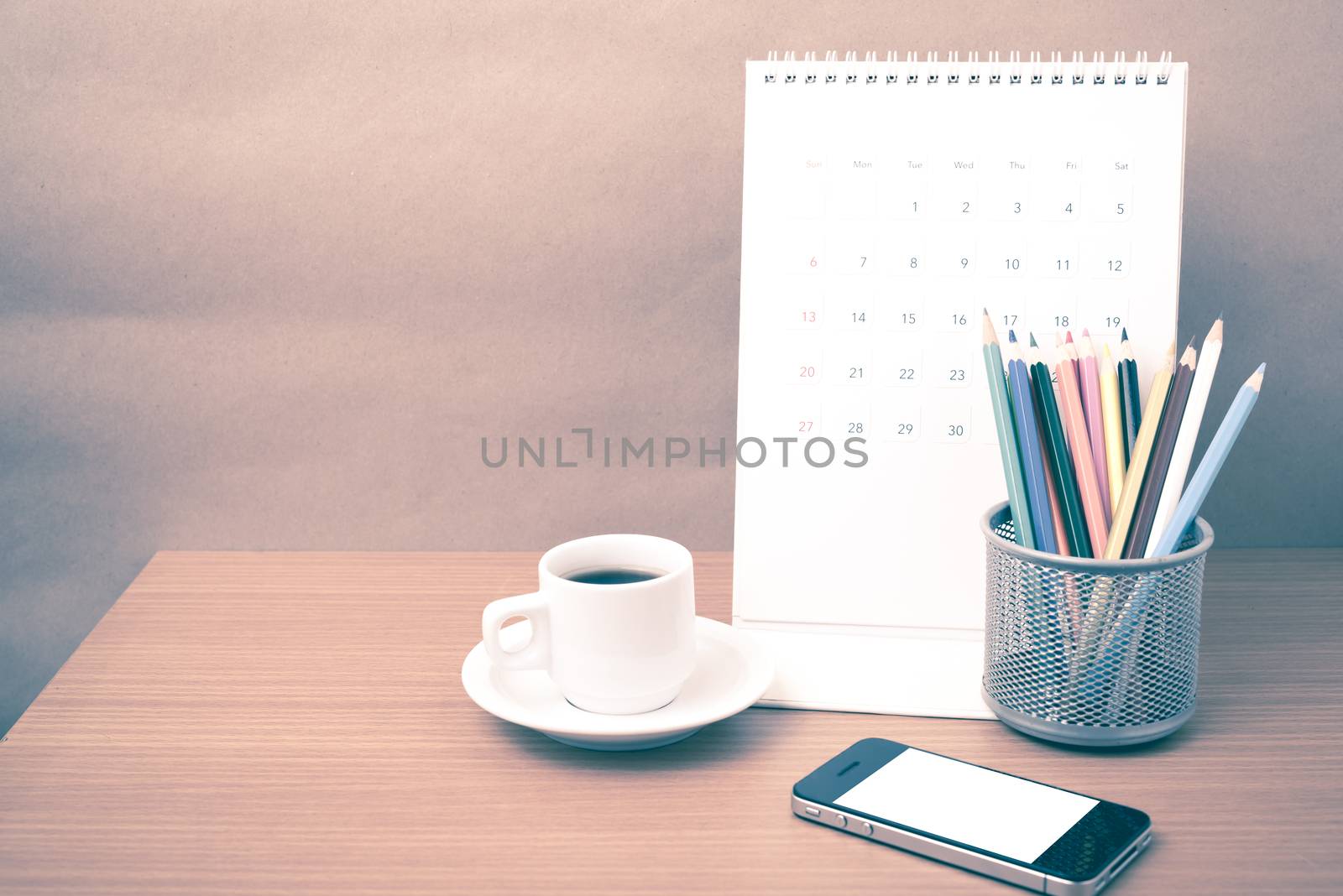 coffee,phone,calendar and color pencil on wood table background vintage style