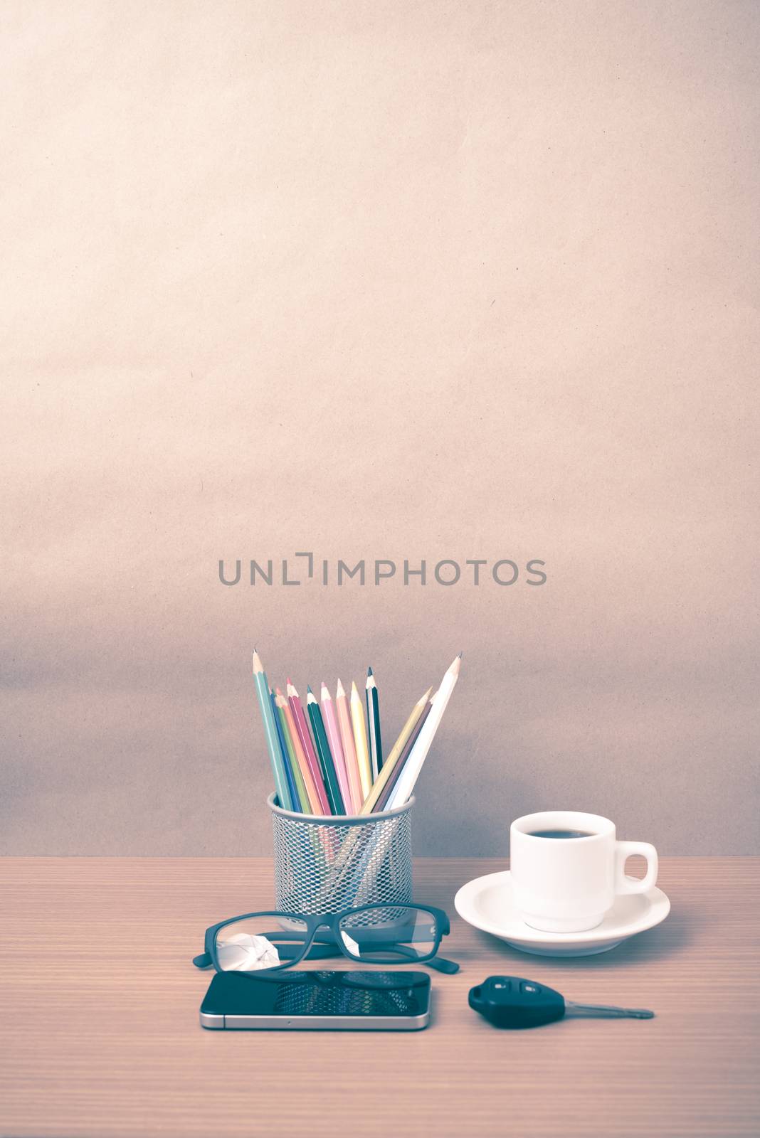 coffee,phone,eyeglasses,color pencil and car key on wood table background vintage style