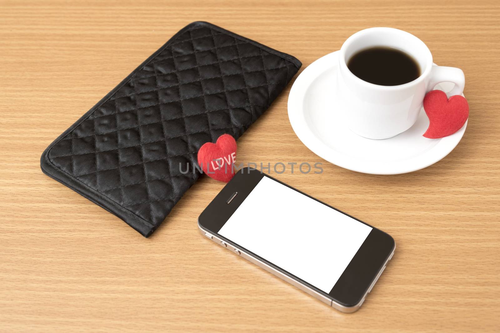 coffee,phone,wallet and heart on wood table background