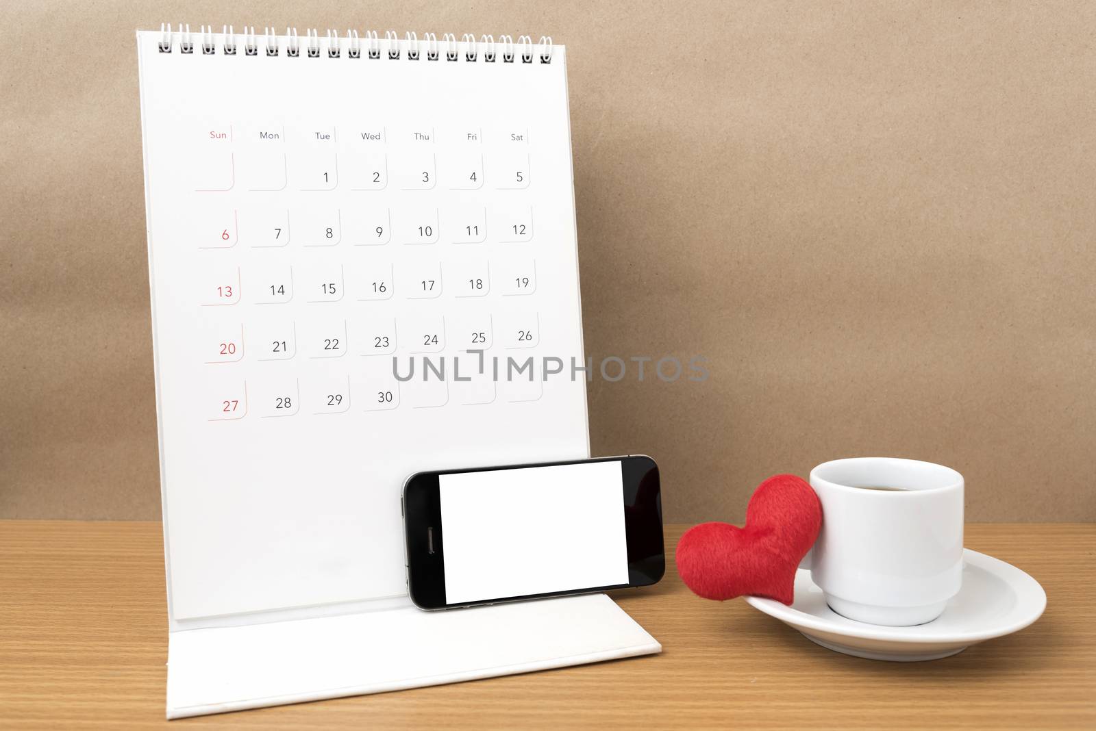 coffee,phone,calendar and heart on wood table background