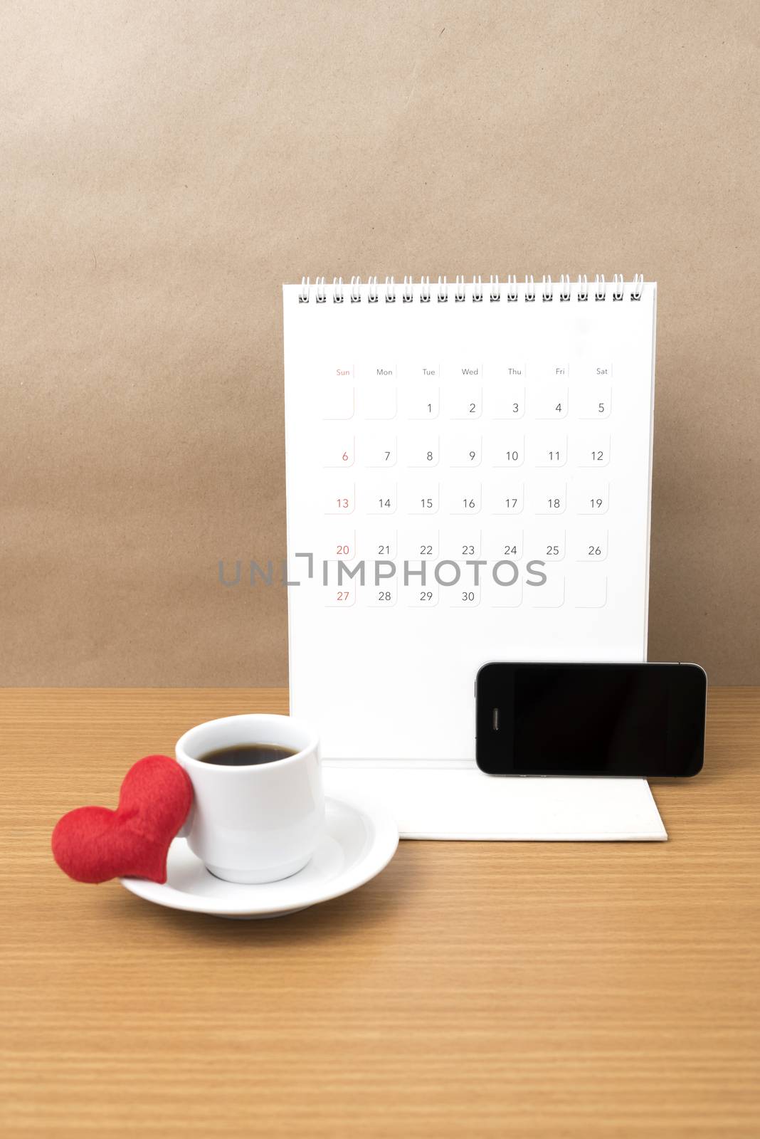 coffee,phone,calendar and heart on wood table background