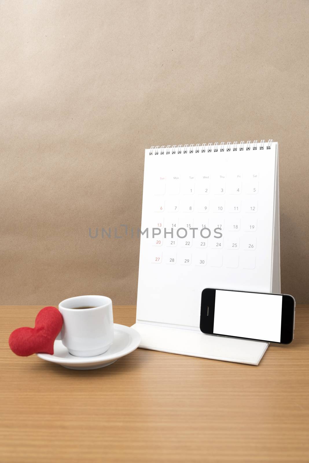 coffee,phone,calendar and heart on wood table background