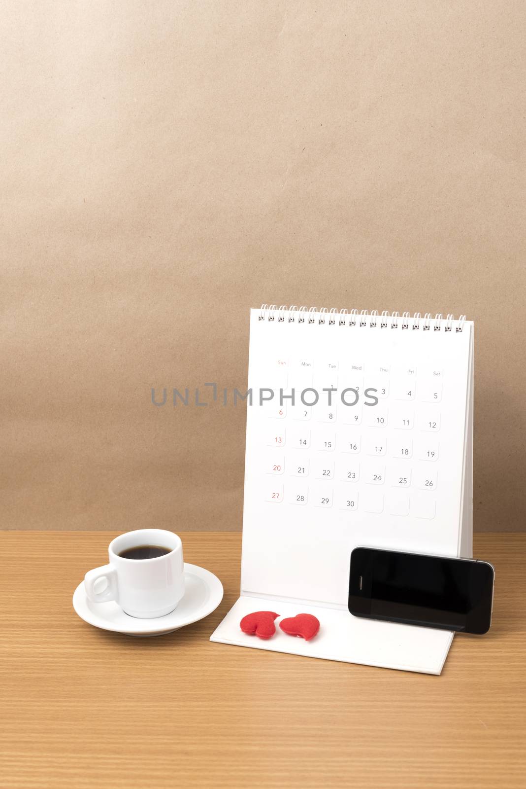 coffee,phone,calendar and heart on wood table background