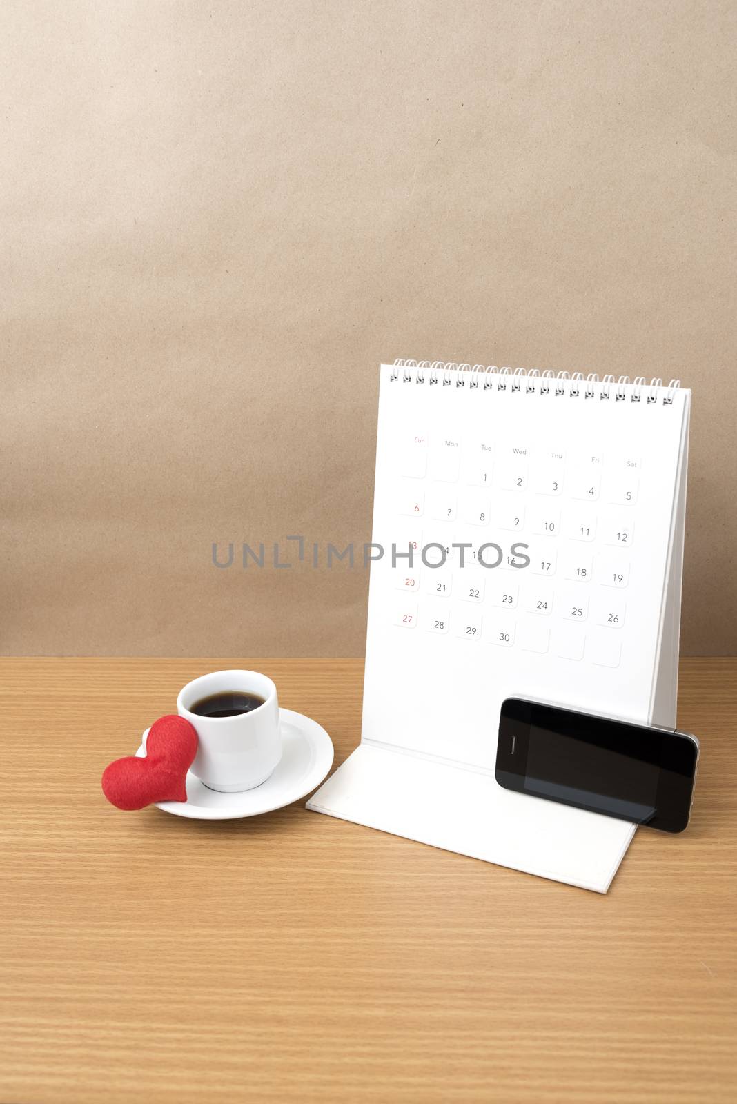 coffee,phone,calendar and heart on wood table background