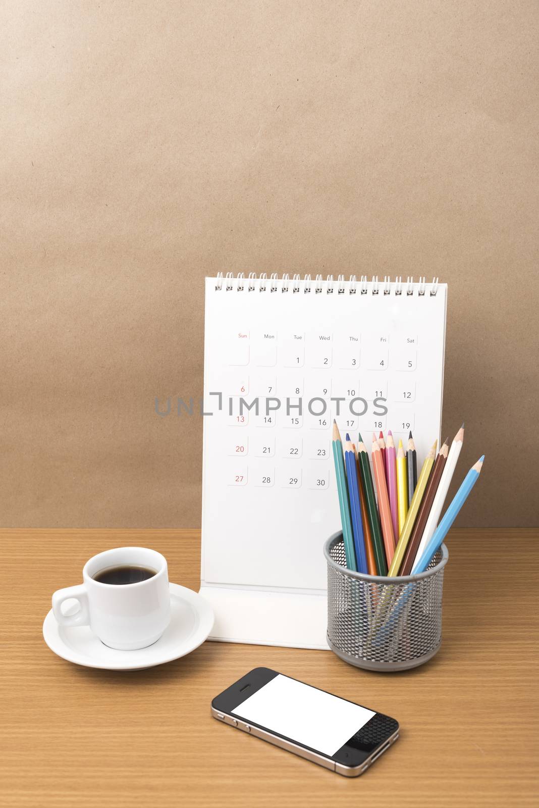 coffee,phone,calendar and color pencil on wood table background