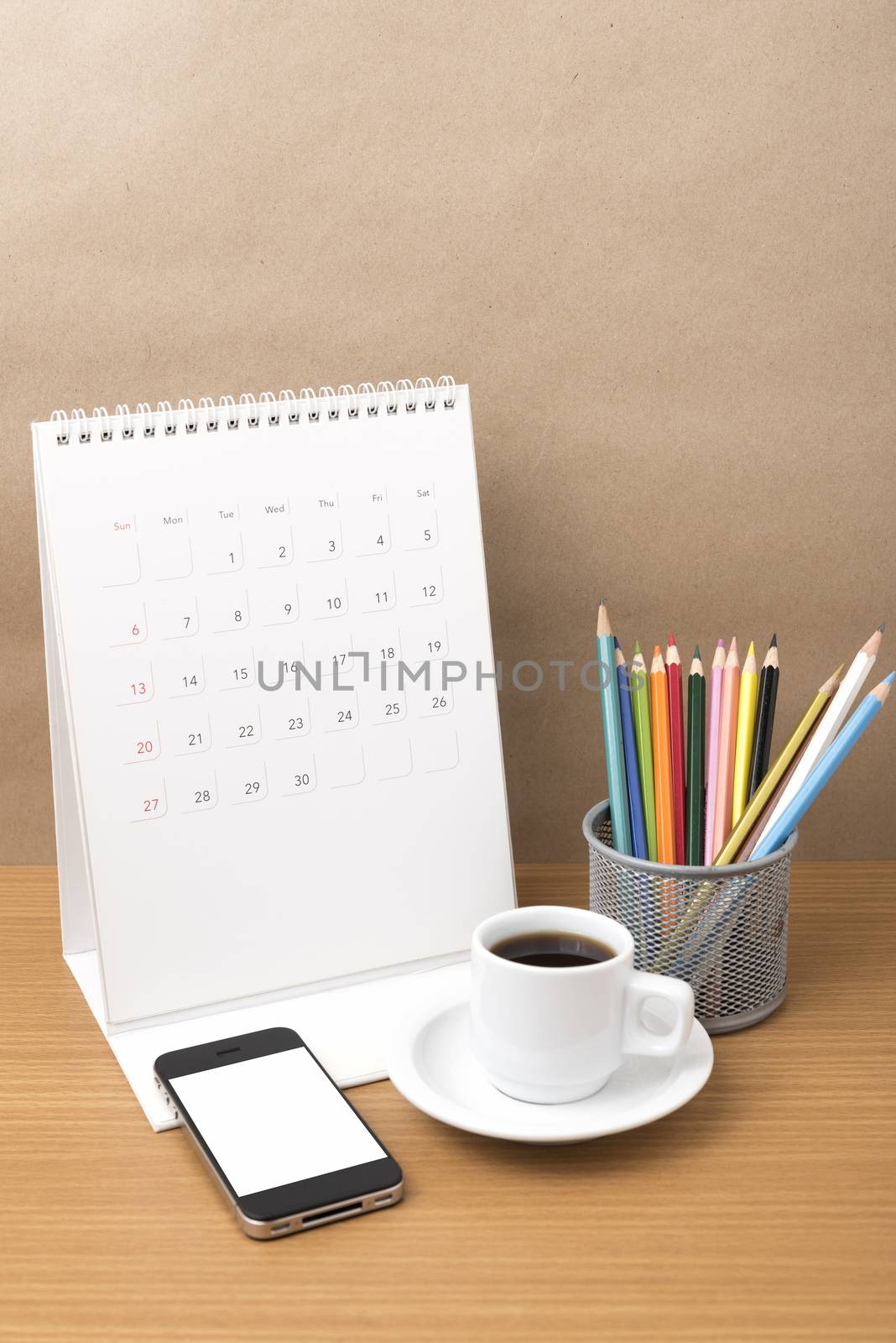 coffee,phone,calendar and color pencil on wood table background