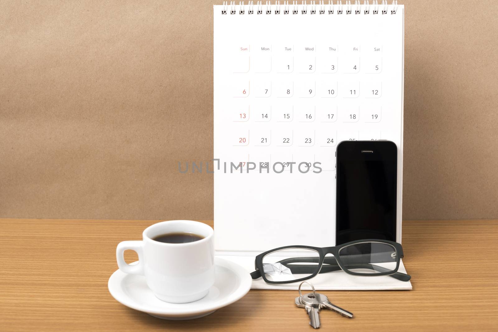 coffee,phone,eyeglasses,calendar and key on wood table background