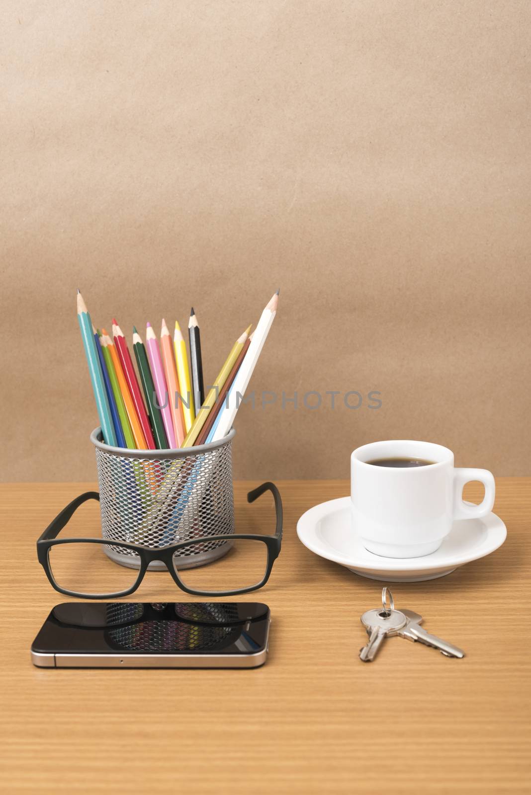 coffee,phone,eyeglasses,color pencil and key on wood table background